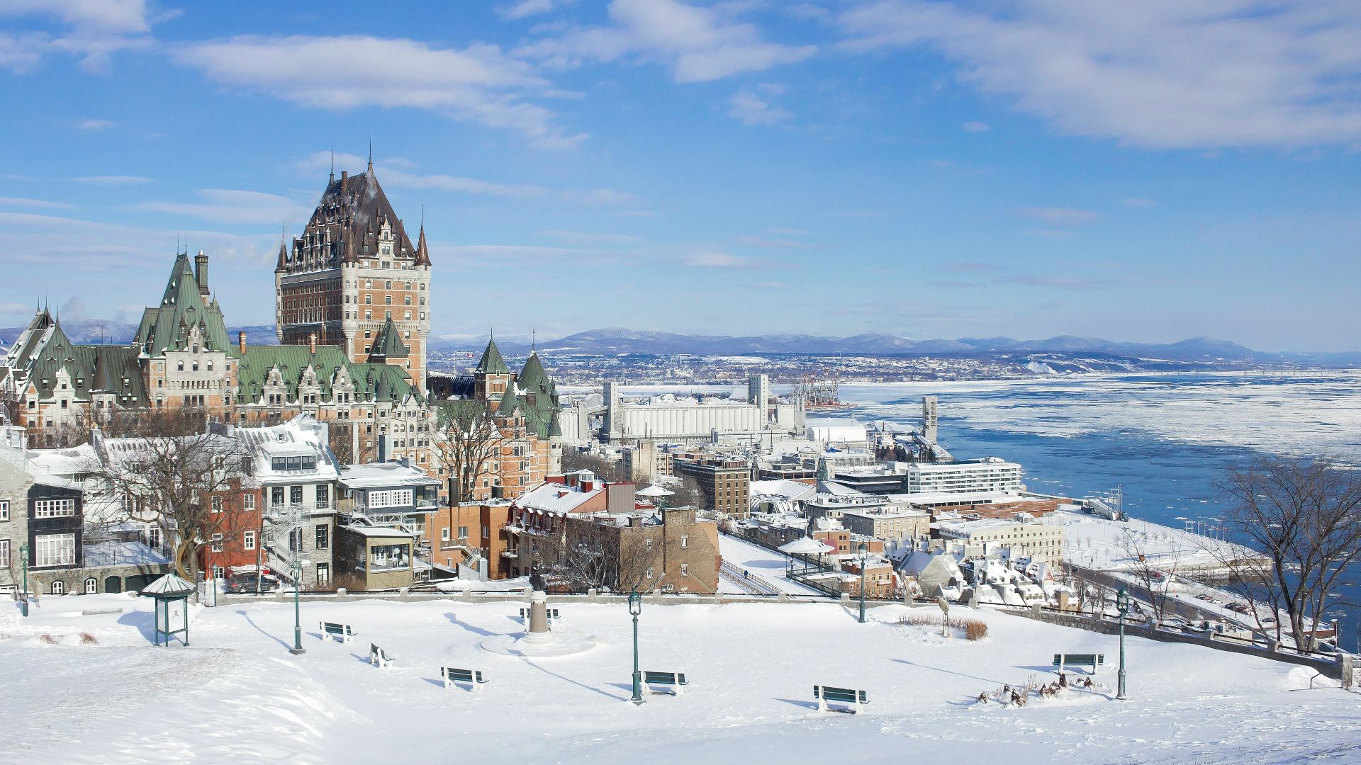 white and brown concrete buildings near body of water during daytime