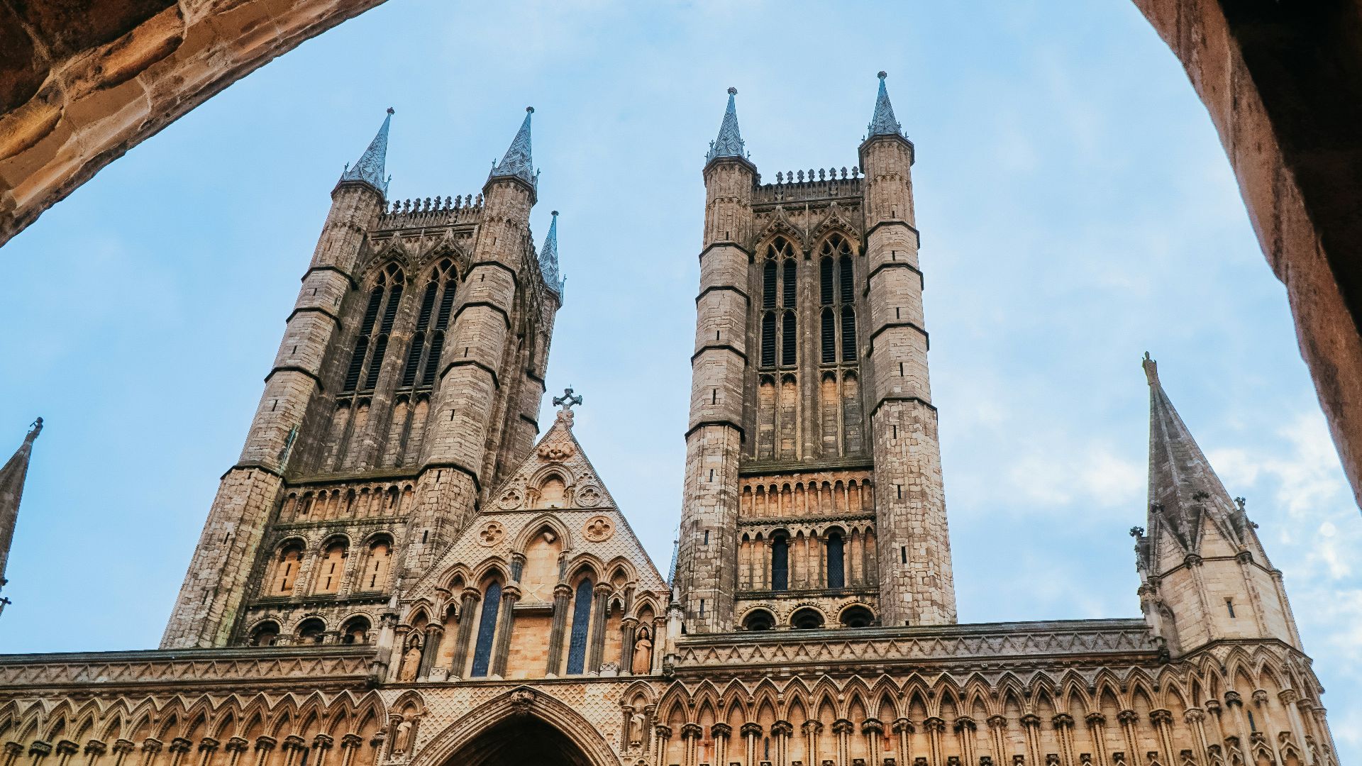 Gothic cathedral towers seen through stone archway