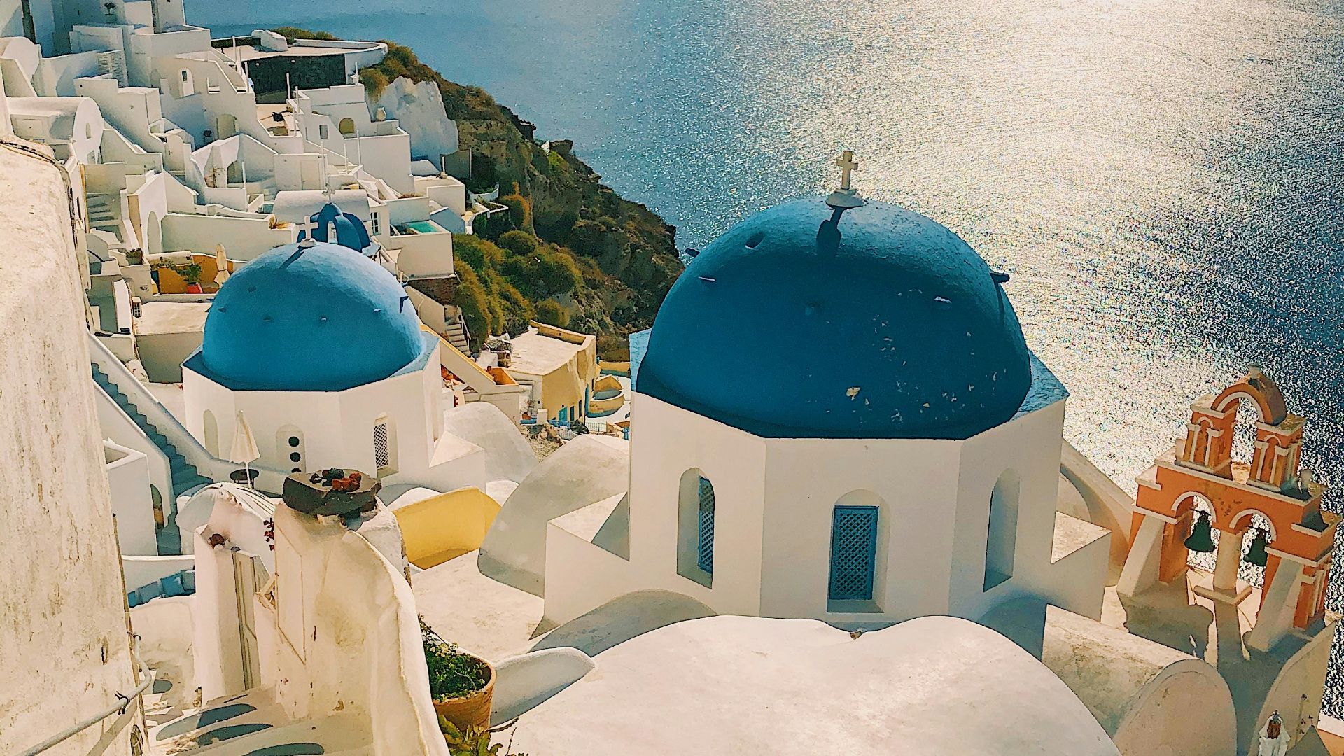 white and blue concrete building near body of water during daytime
