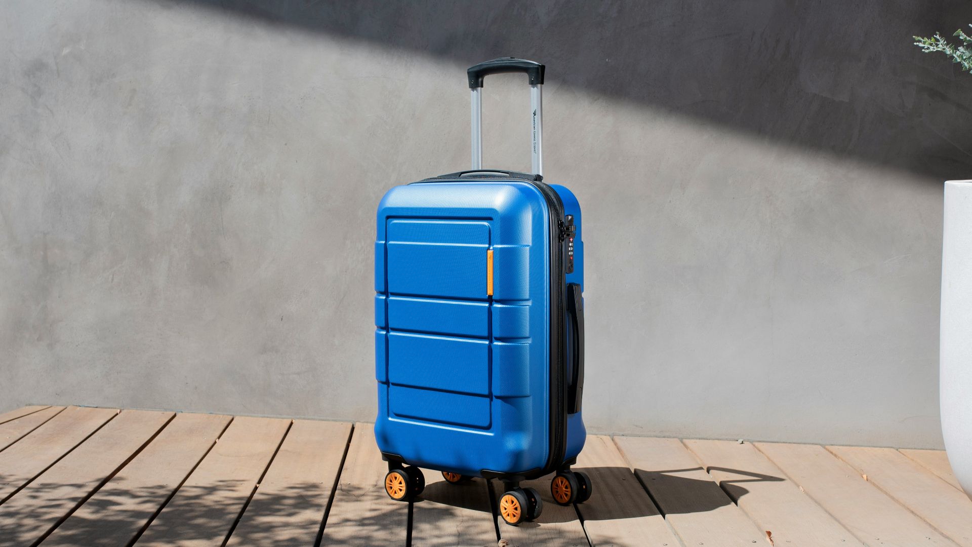a blue suitcase sitting on top of a wooden floor