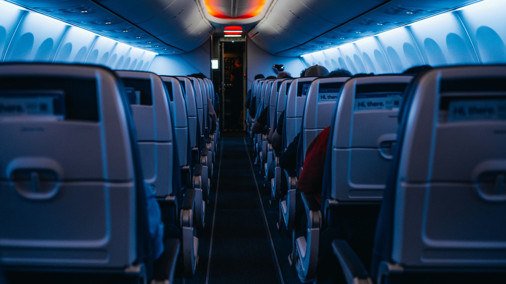 The inside of an airplane with the lights on