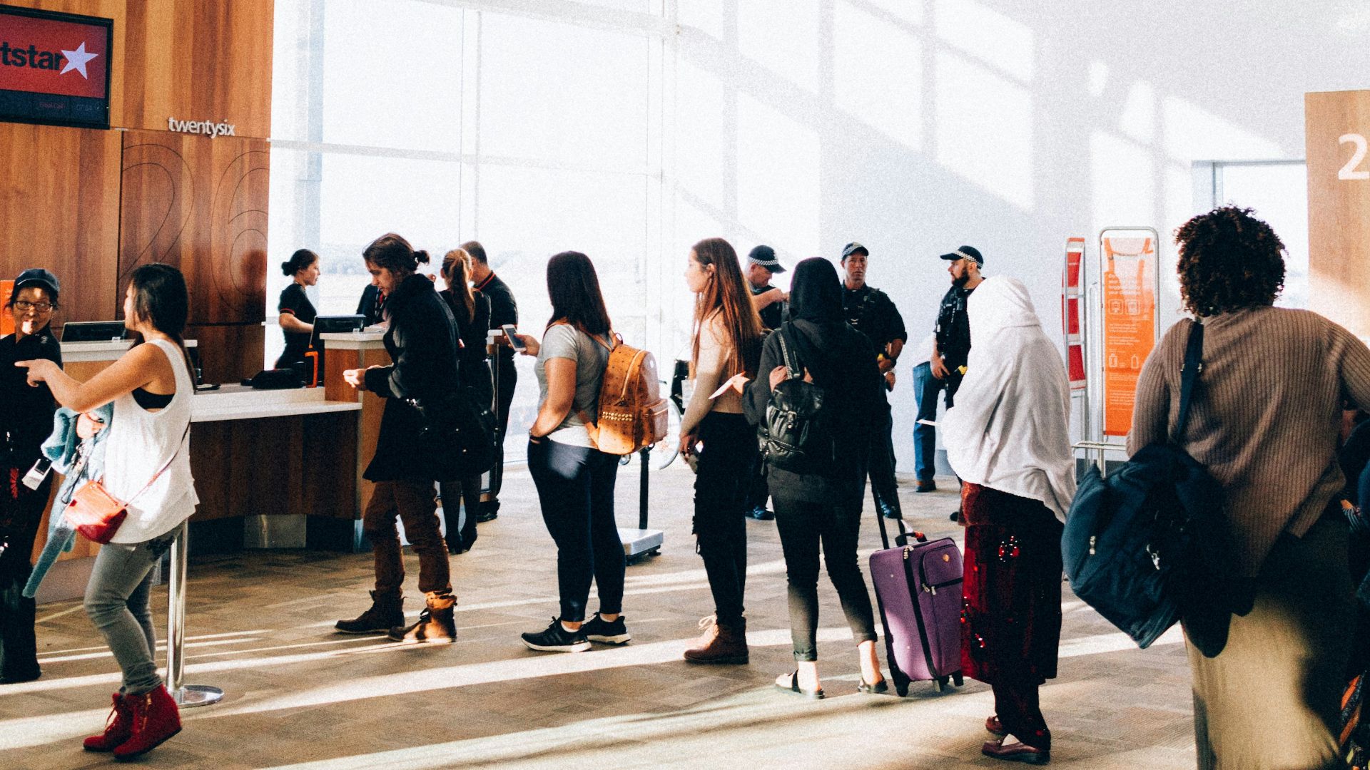 a group of people standing in a large room
