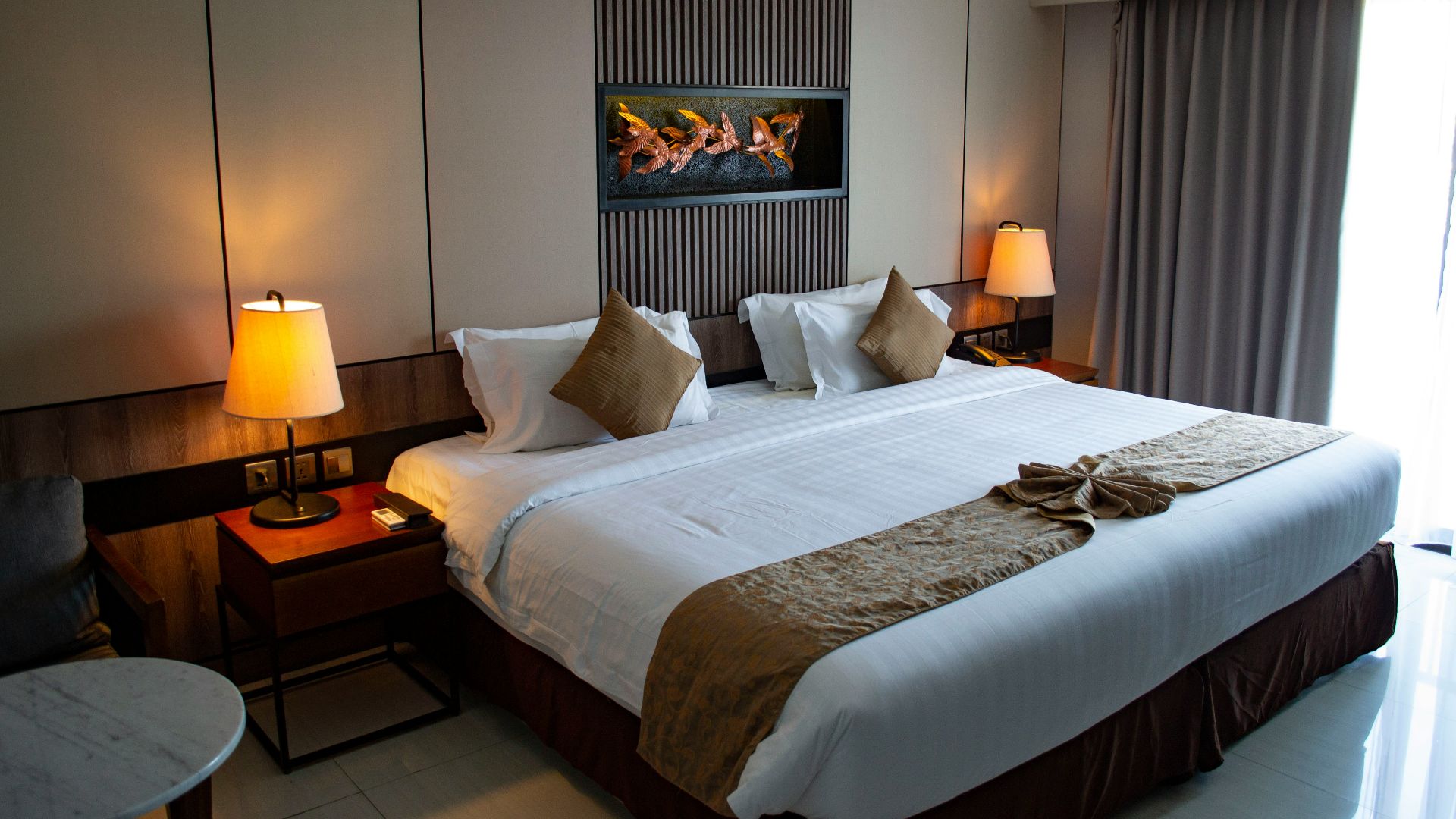 white bed linen with throw pillows