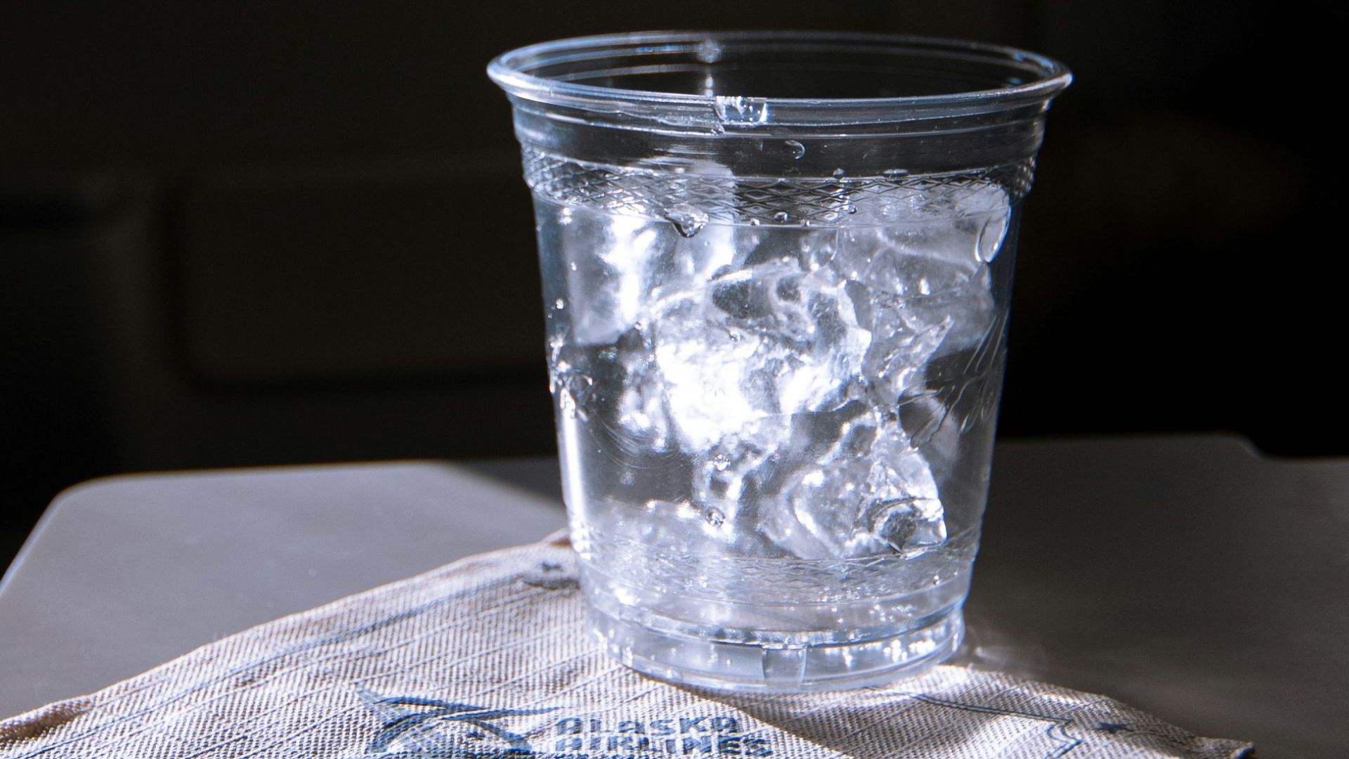clear drinking glass on white paper