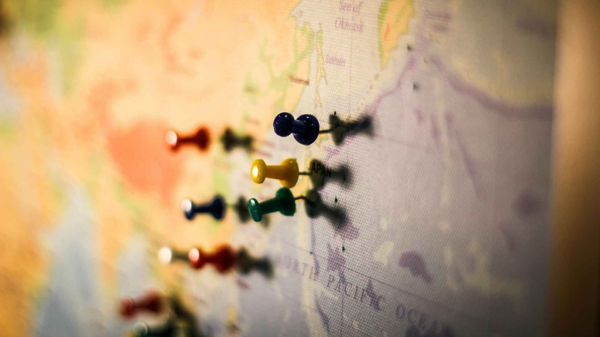 selective focus photography of push pin in map
