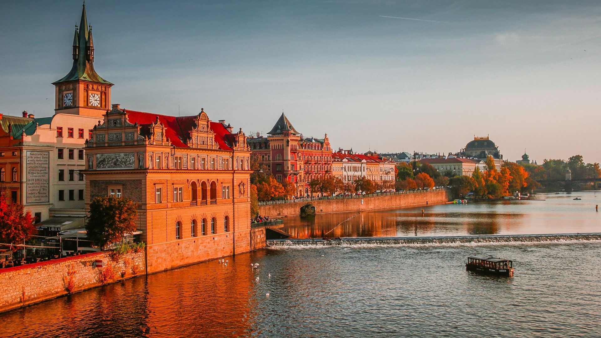 photo of boat on body of water near high-rise buildings