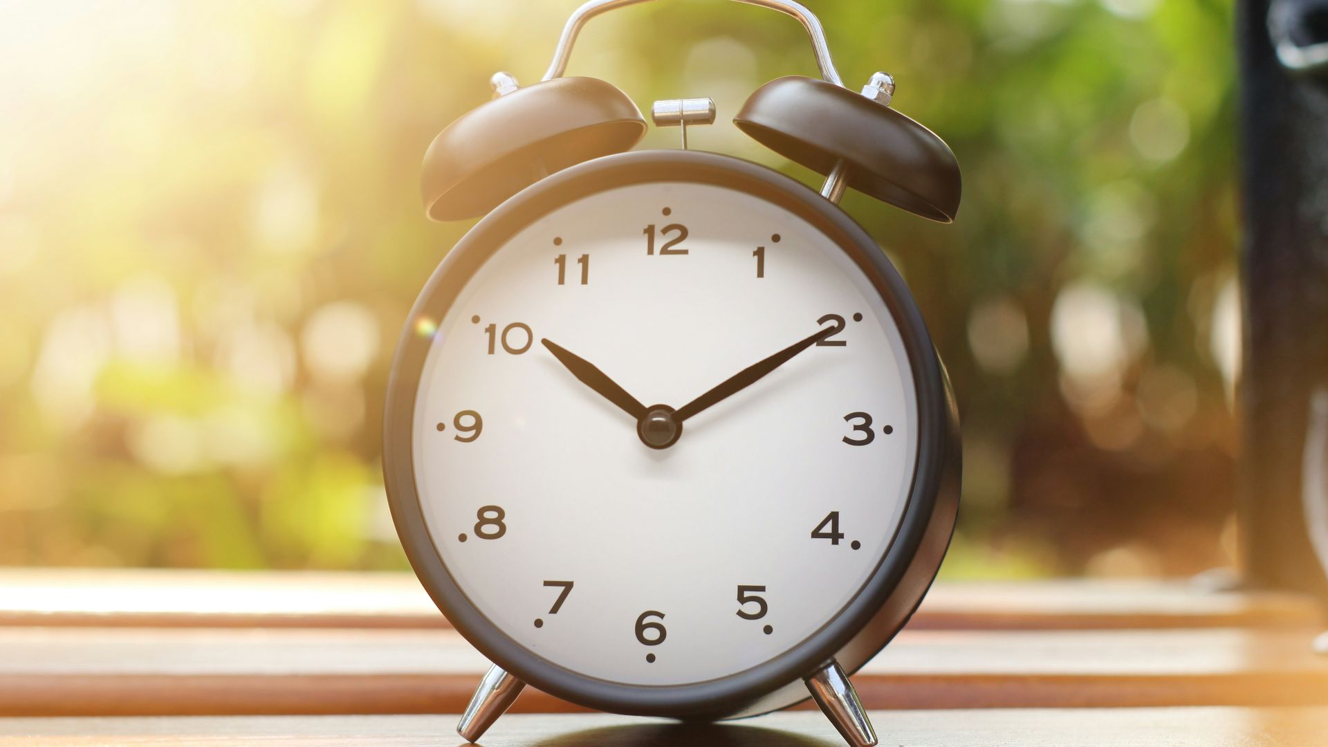 an alarm clock sitting on top of a wooden table