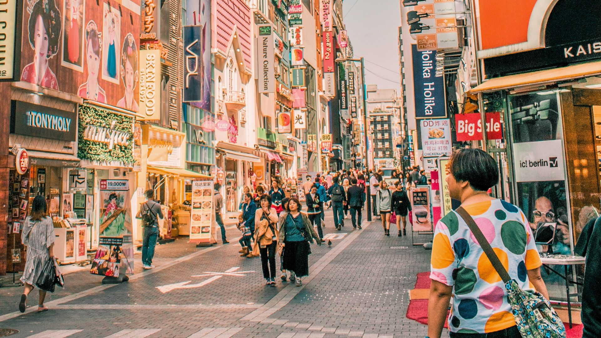 people walking on road surrounded by buildings