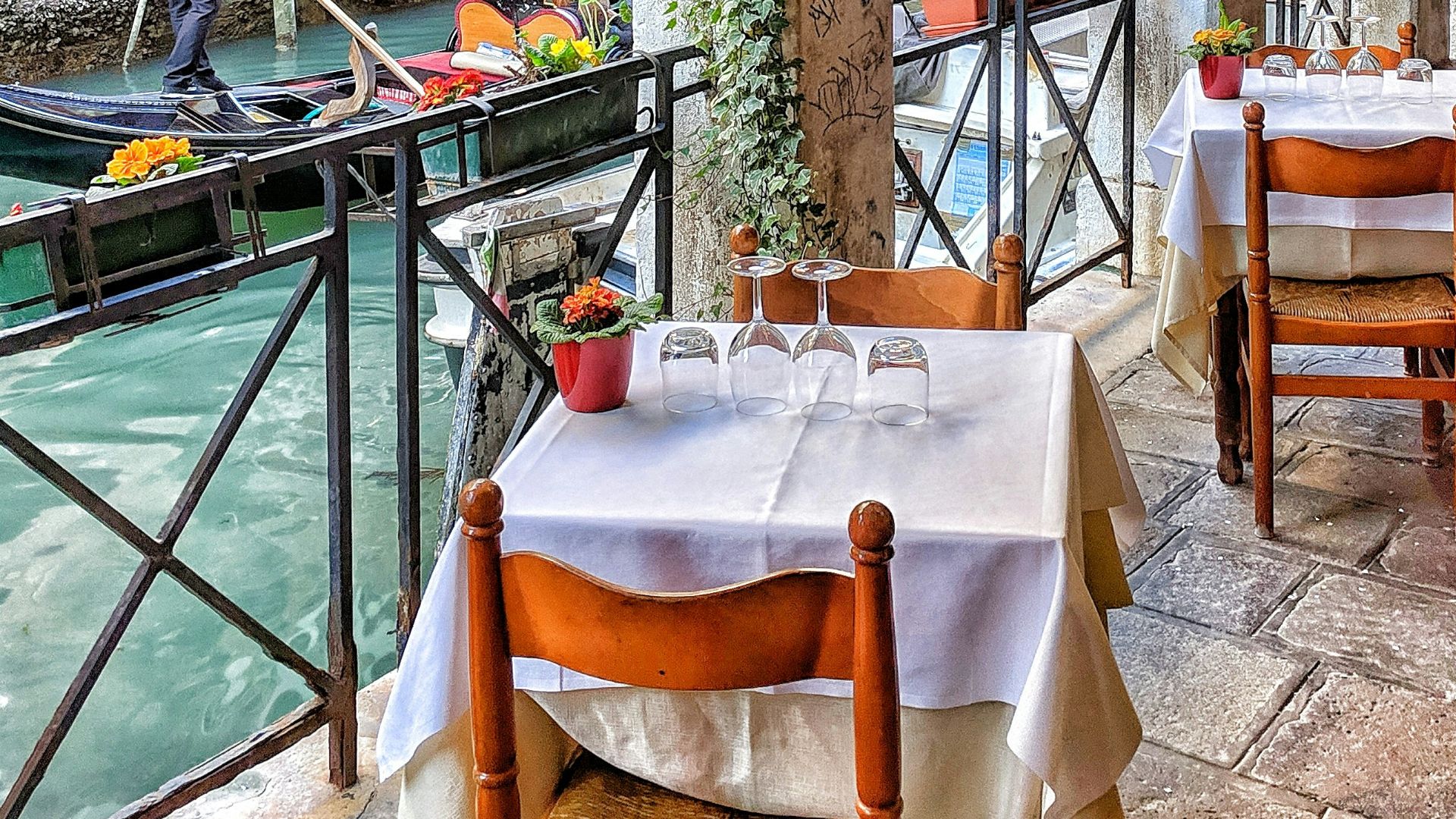 man riding on boat beside restaurant