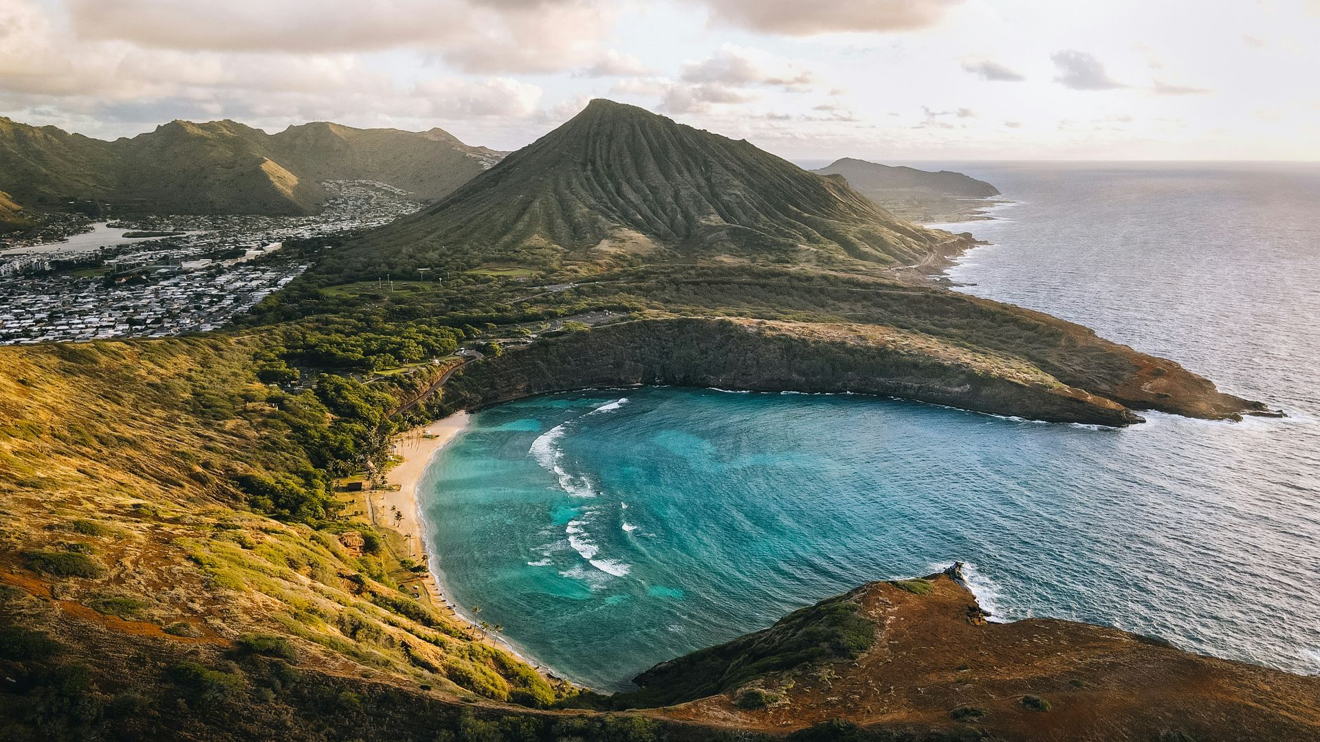 an aerial view of a beach and a mountain