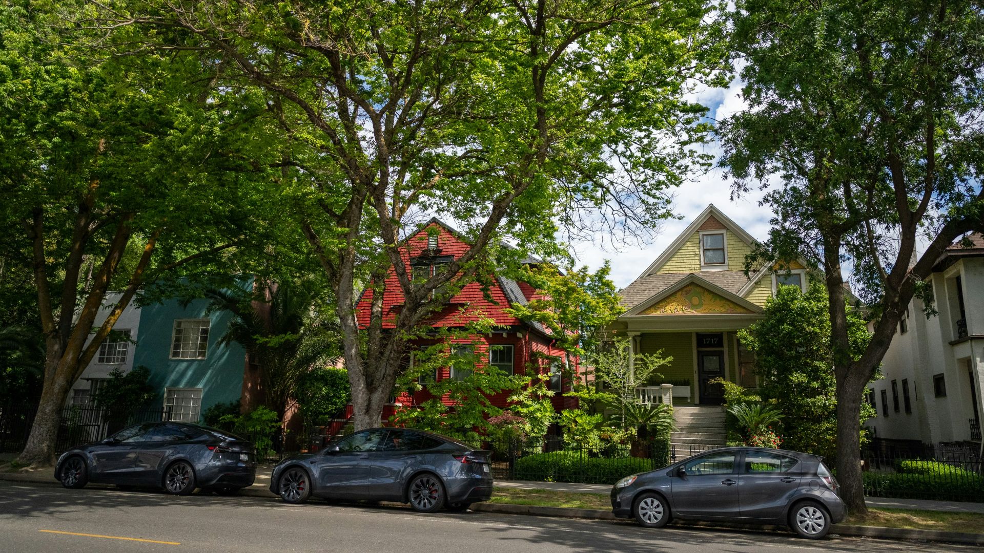 three cars parked on the side of the road