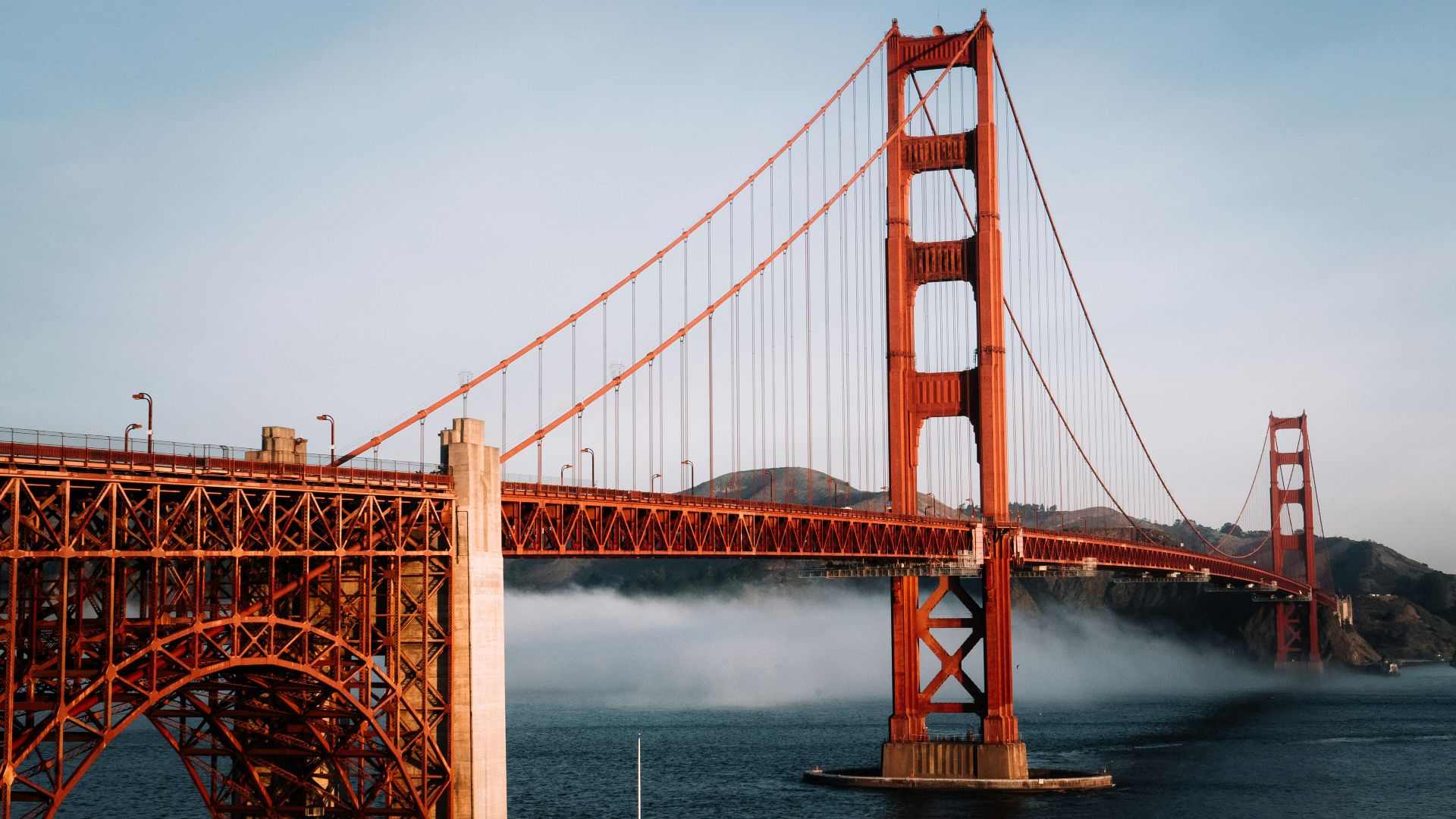 The golden gate bridge is surrounded by fog