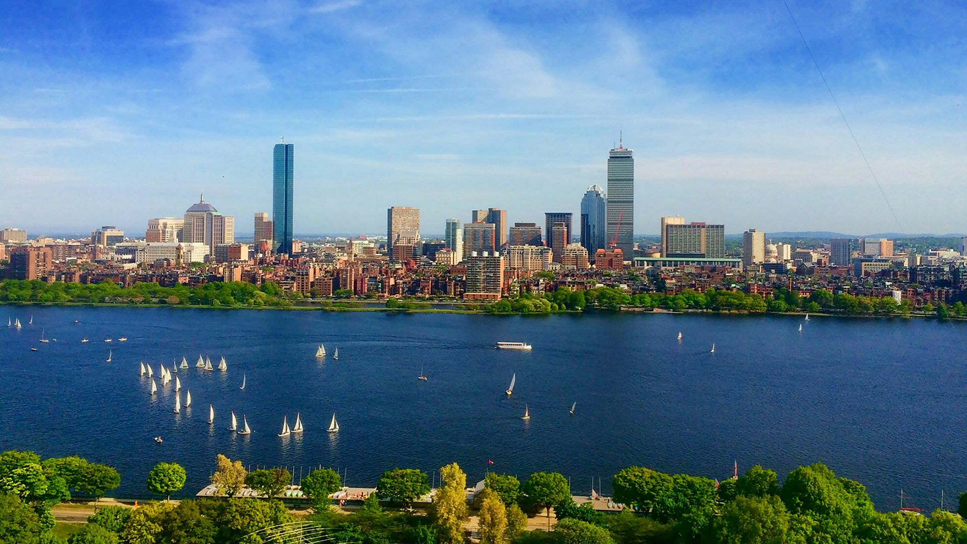 body of water near cityscape at daytime