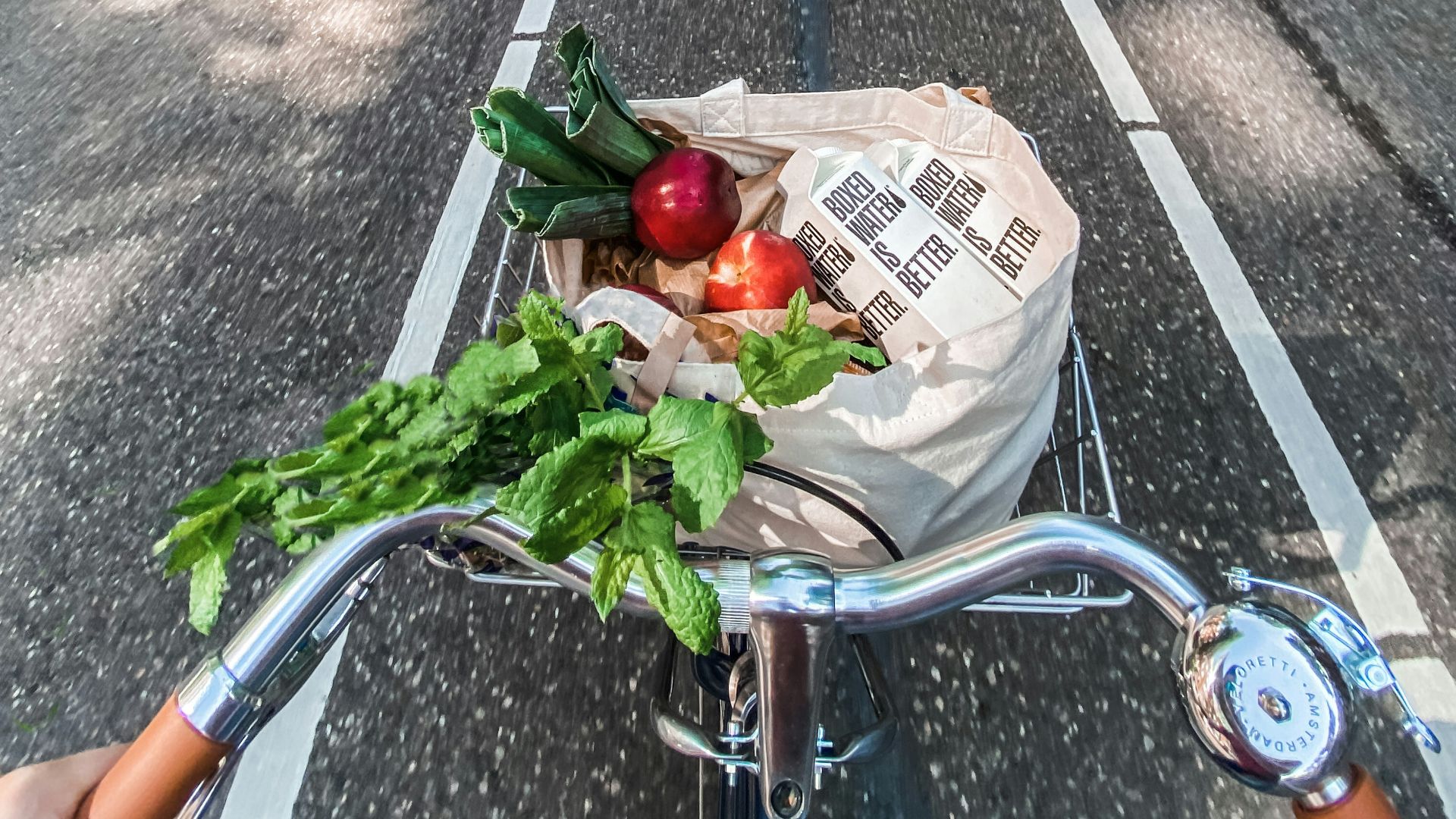 red roses in brown cardboard box on bicycle