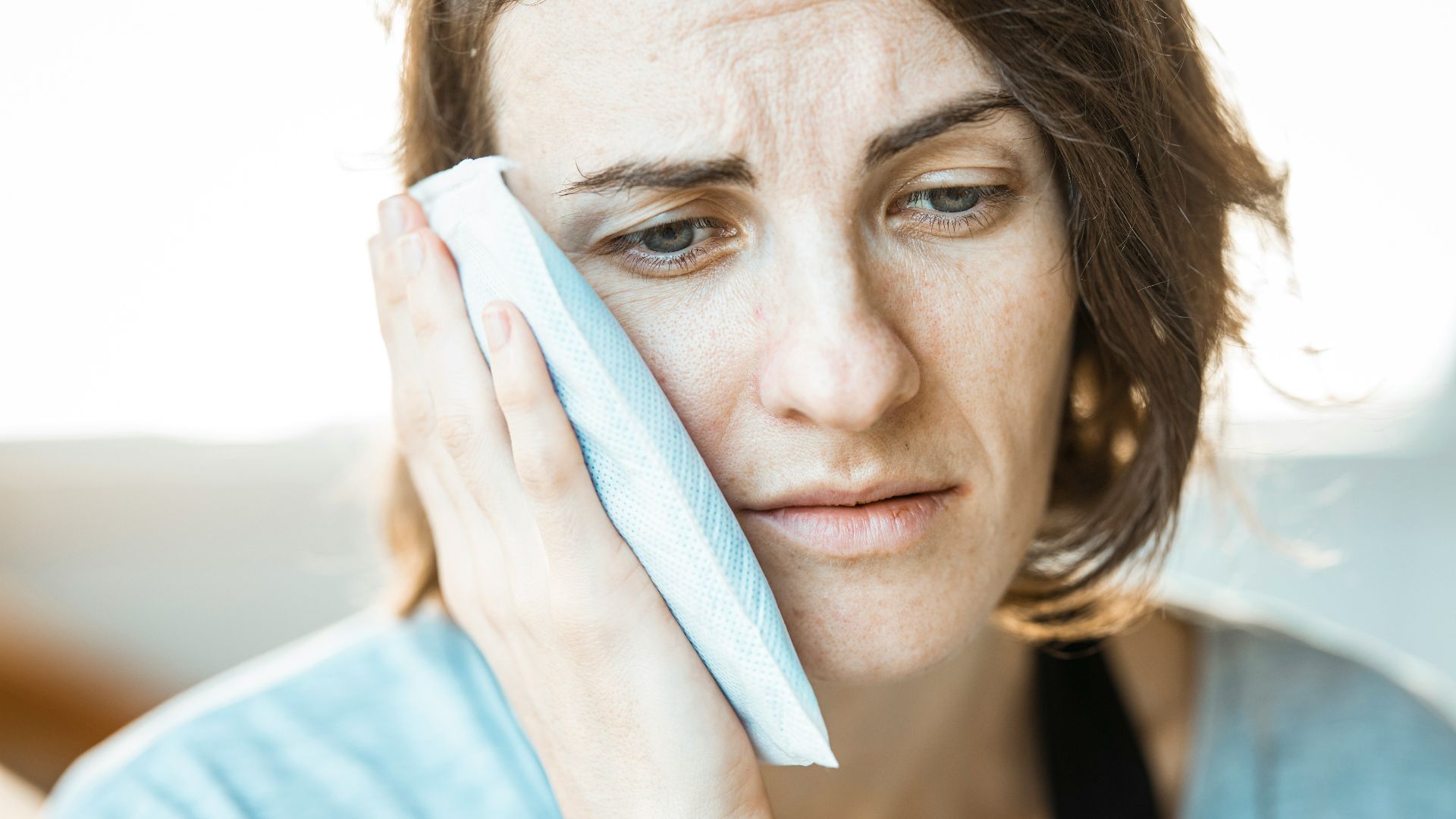 woman in black tank top holding white textile