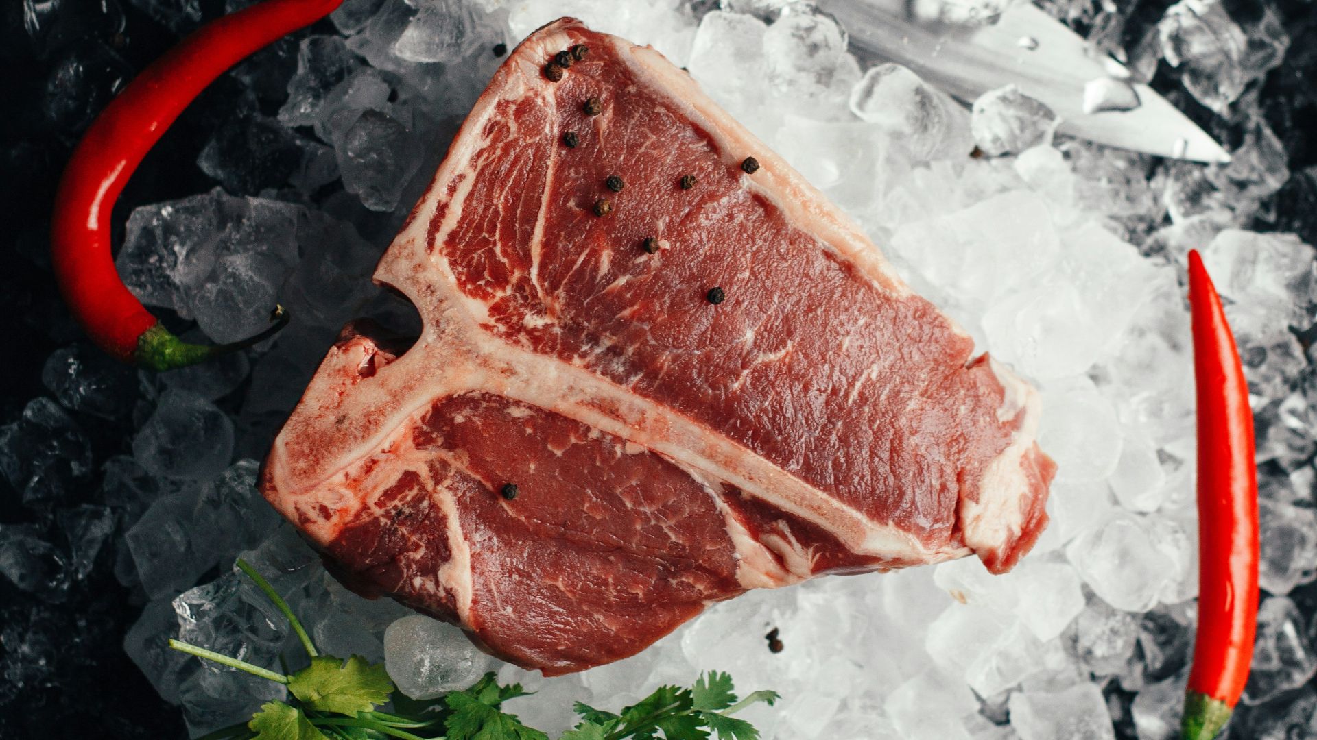 raw meat on ice with coriander and chilis