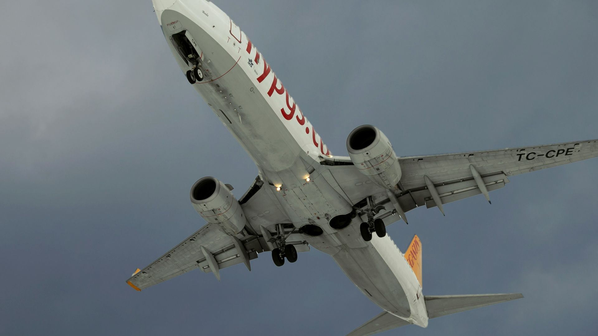 a large jetliner flying through a cloudy sky