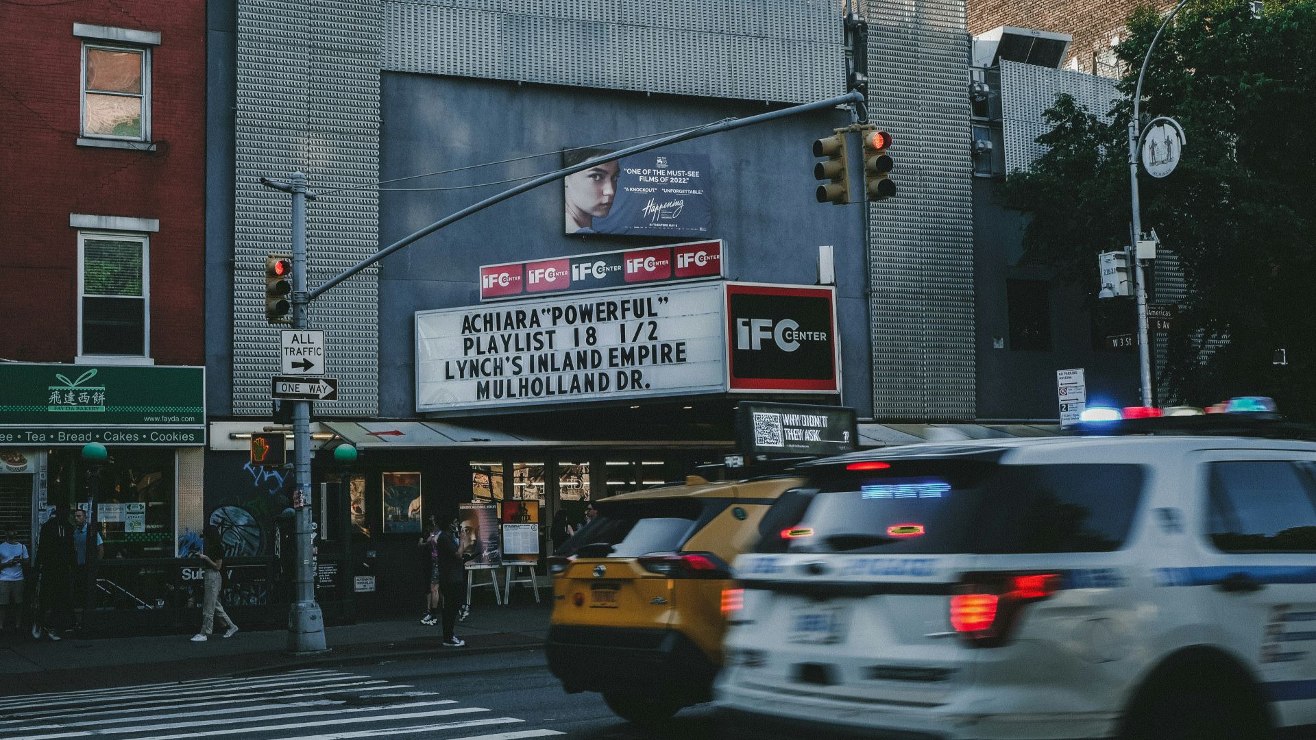 a movie marquee on the corner of a city street