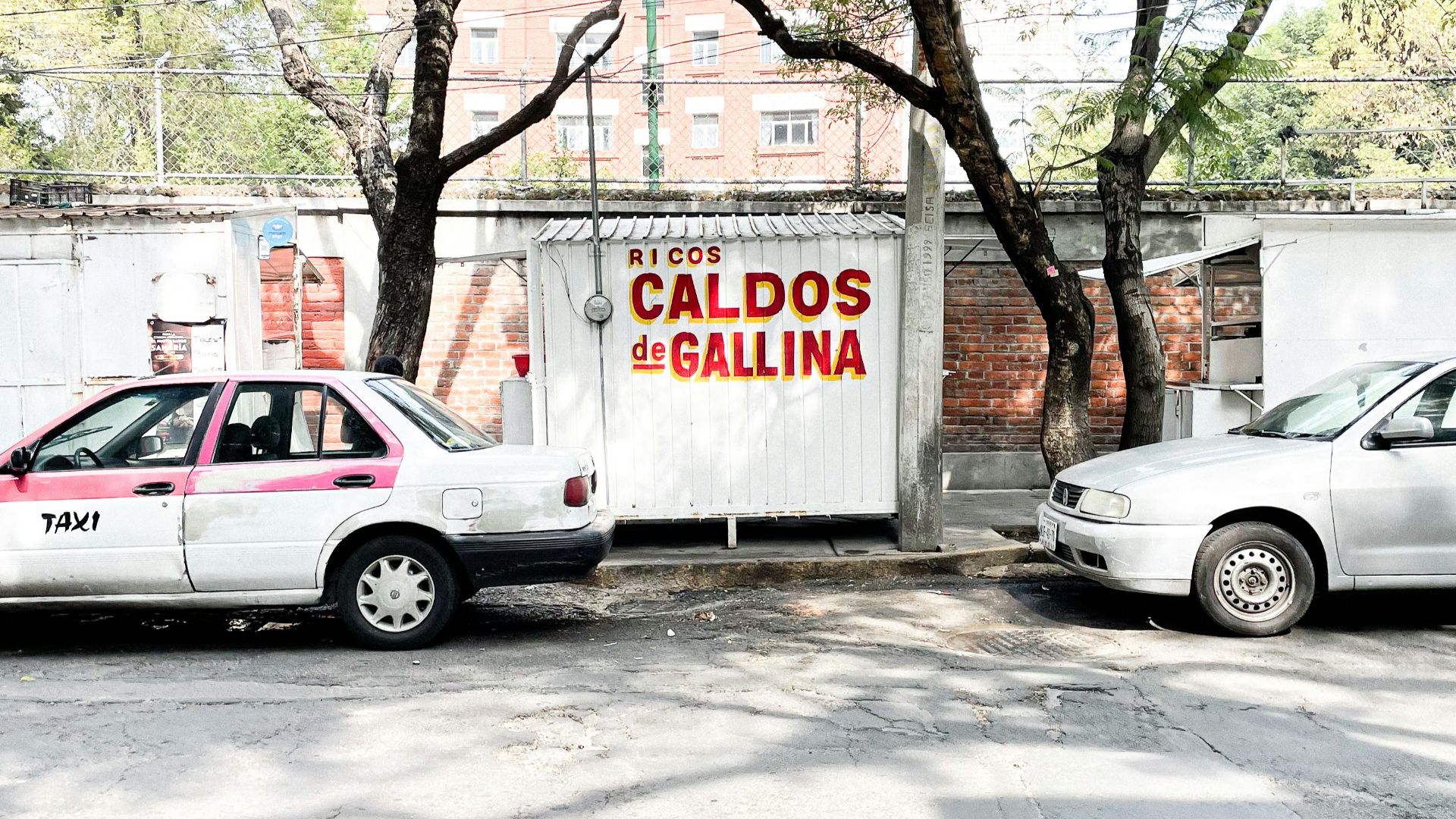 white sedan parked beside white van