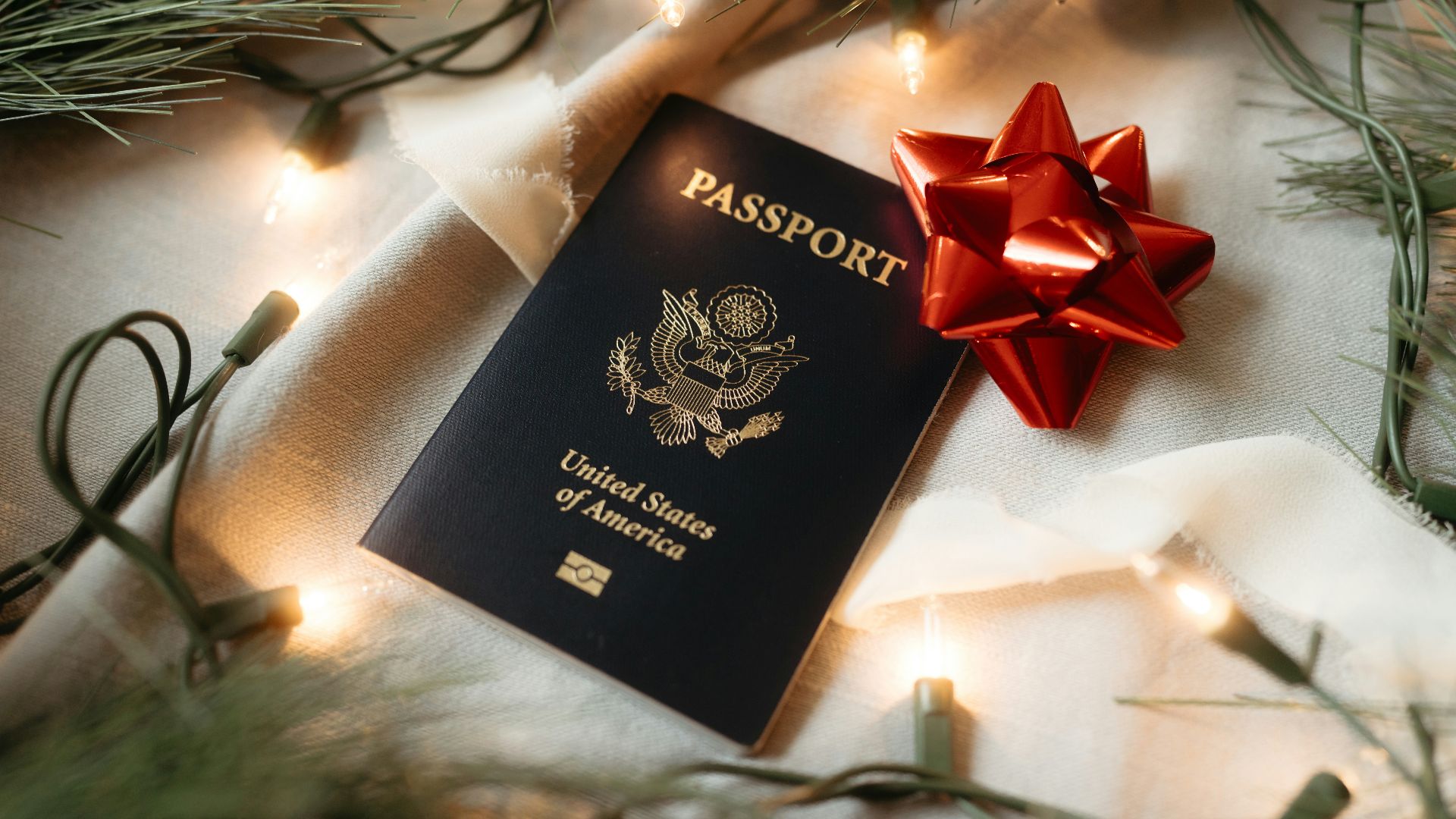 A passport with a red bow on top of it