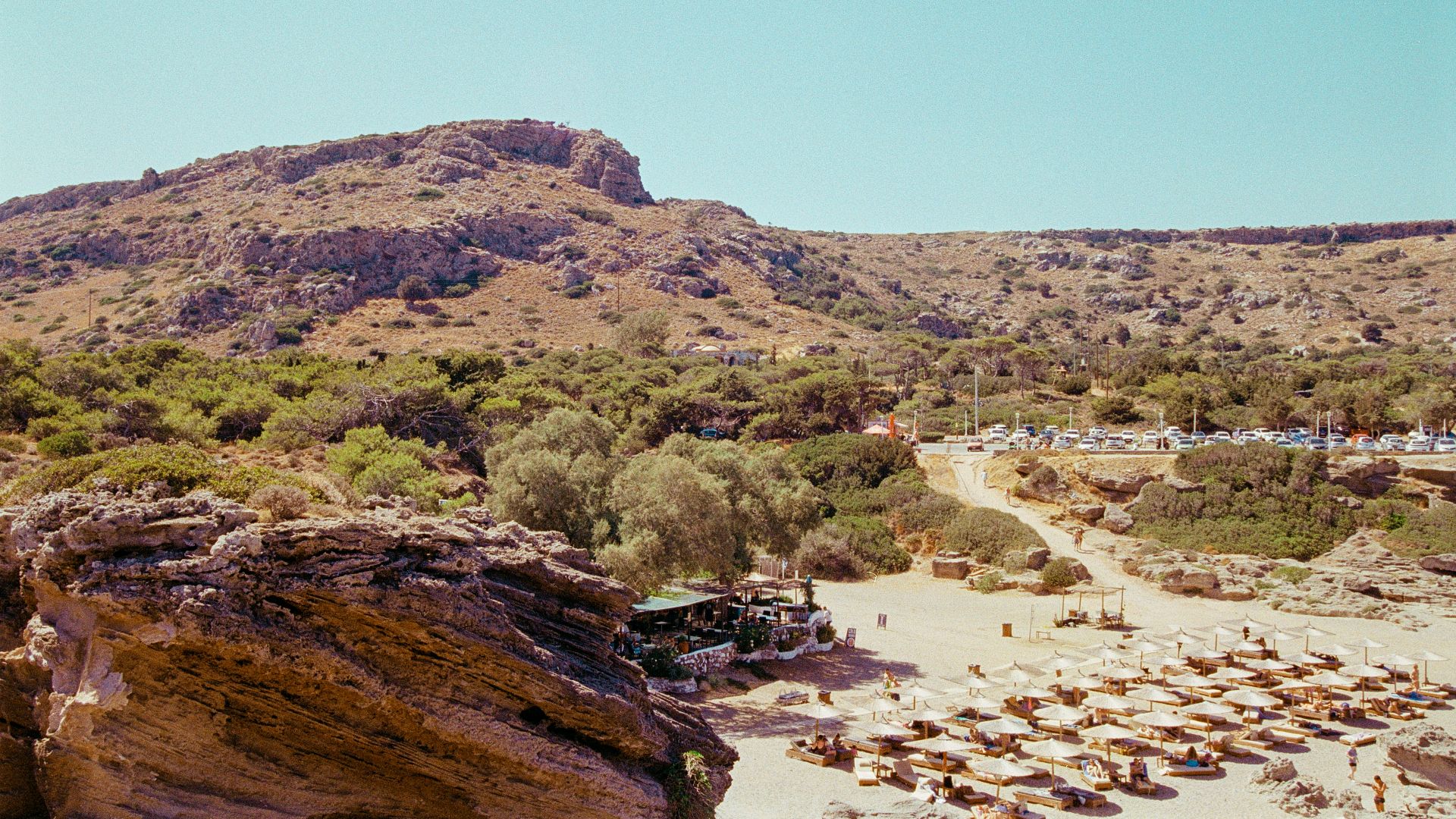 A view of a beach with a mountain in the background