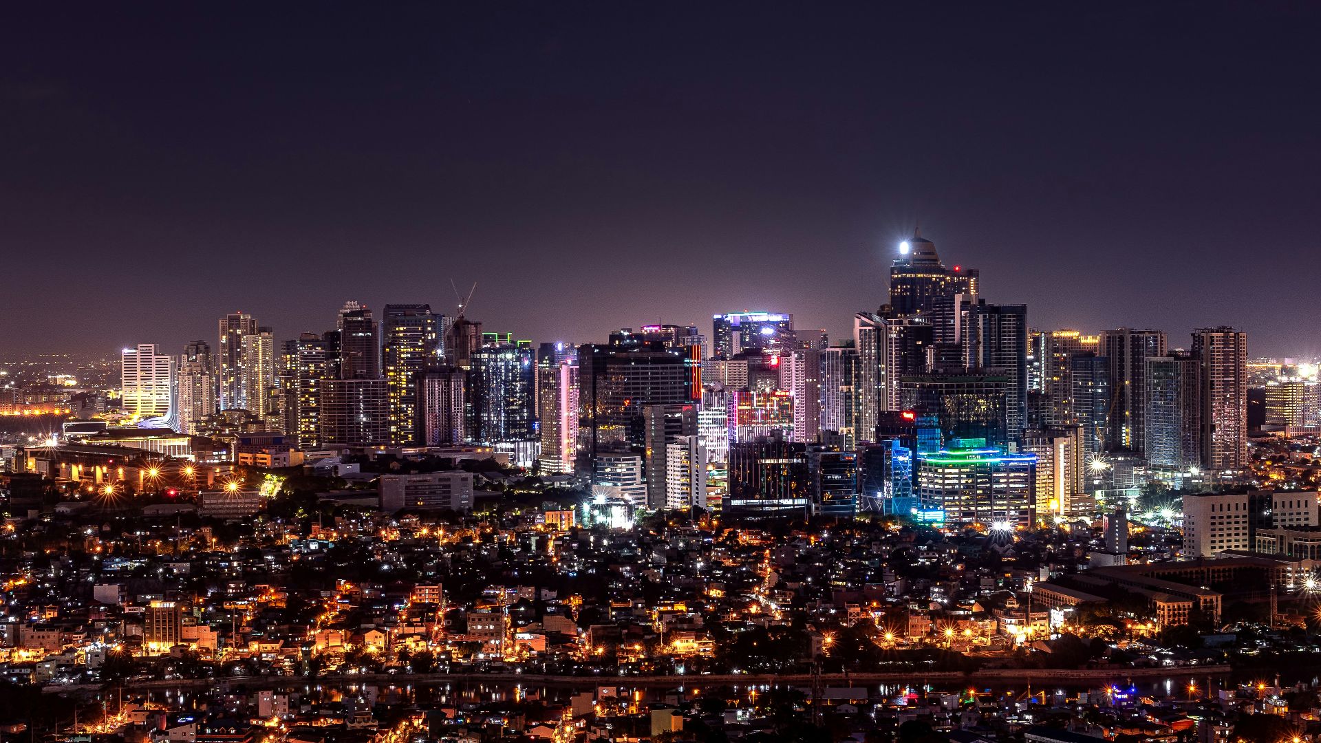 city with high rise buildings during night time