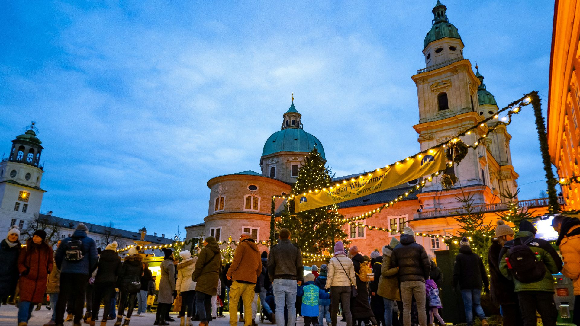 Christmas market with people and festive lights.
