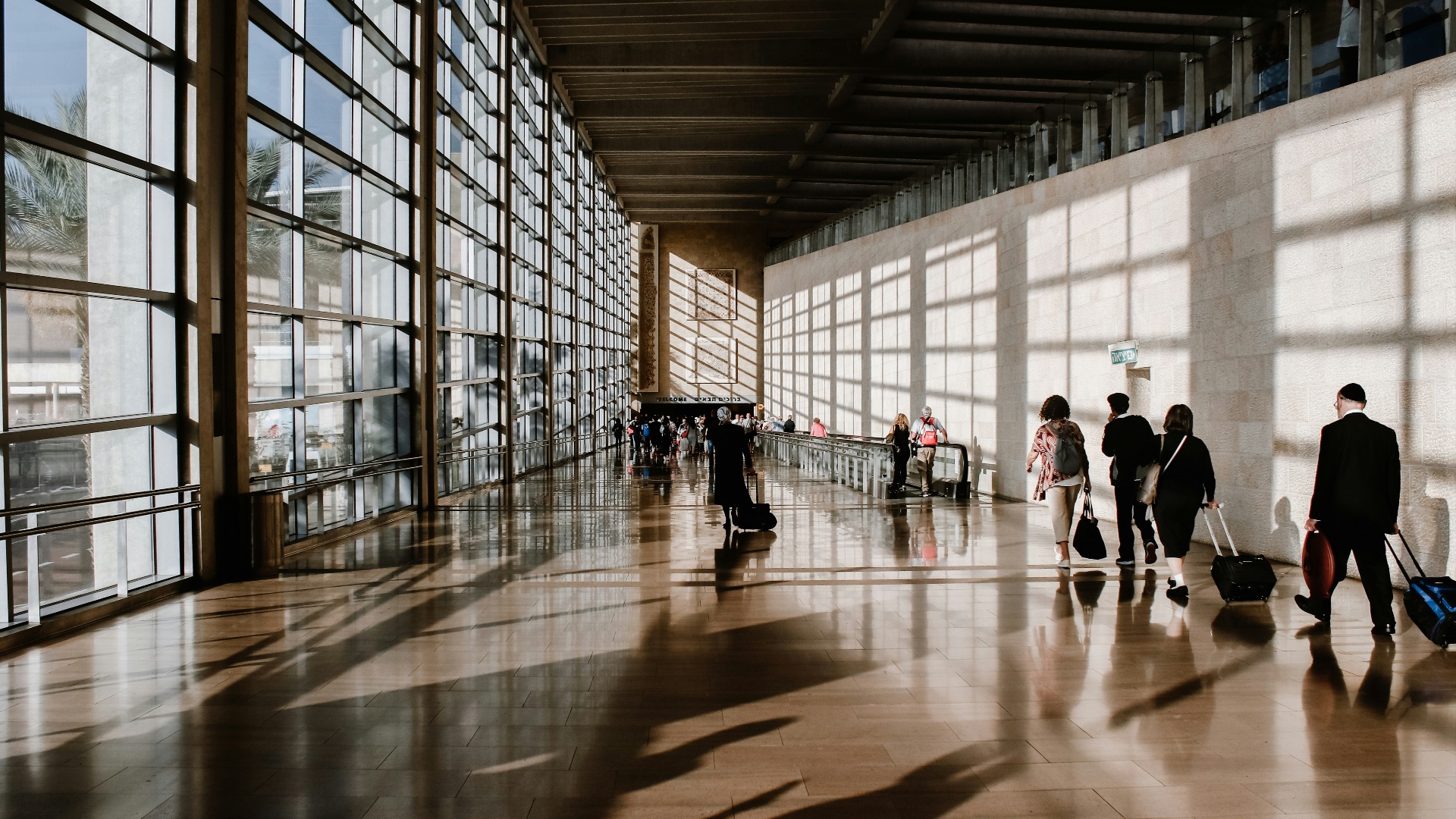 group of people walking beside white building