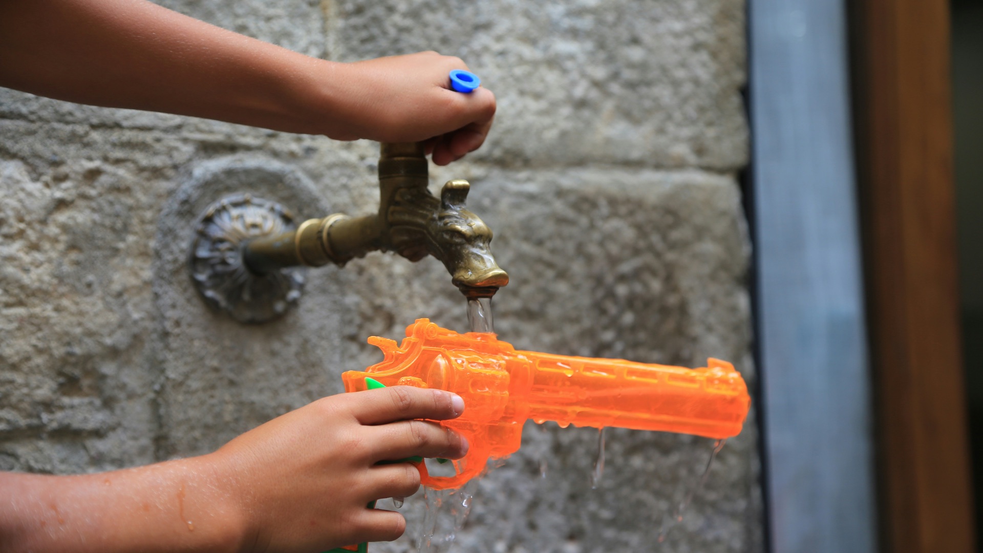 a person holding a water gun in their hand