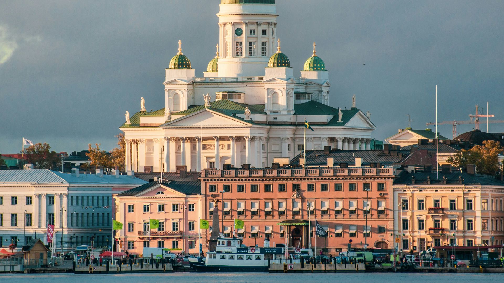 white concrete mosque near body of water