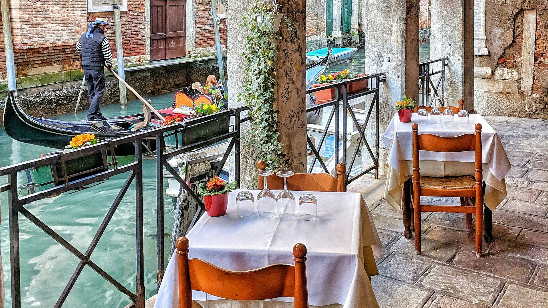 man riding on boat beside restaurant