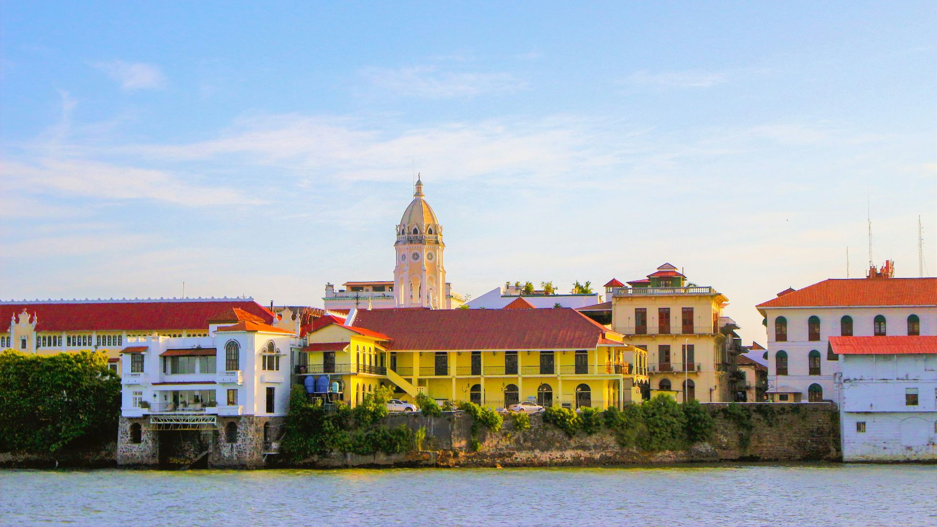 a large body of water next to a row of buildings