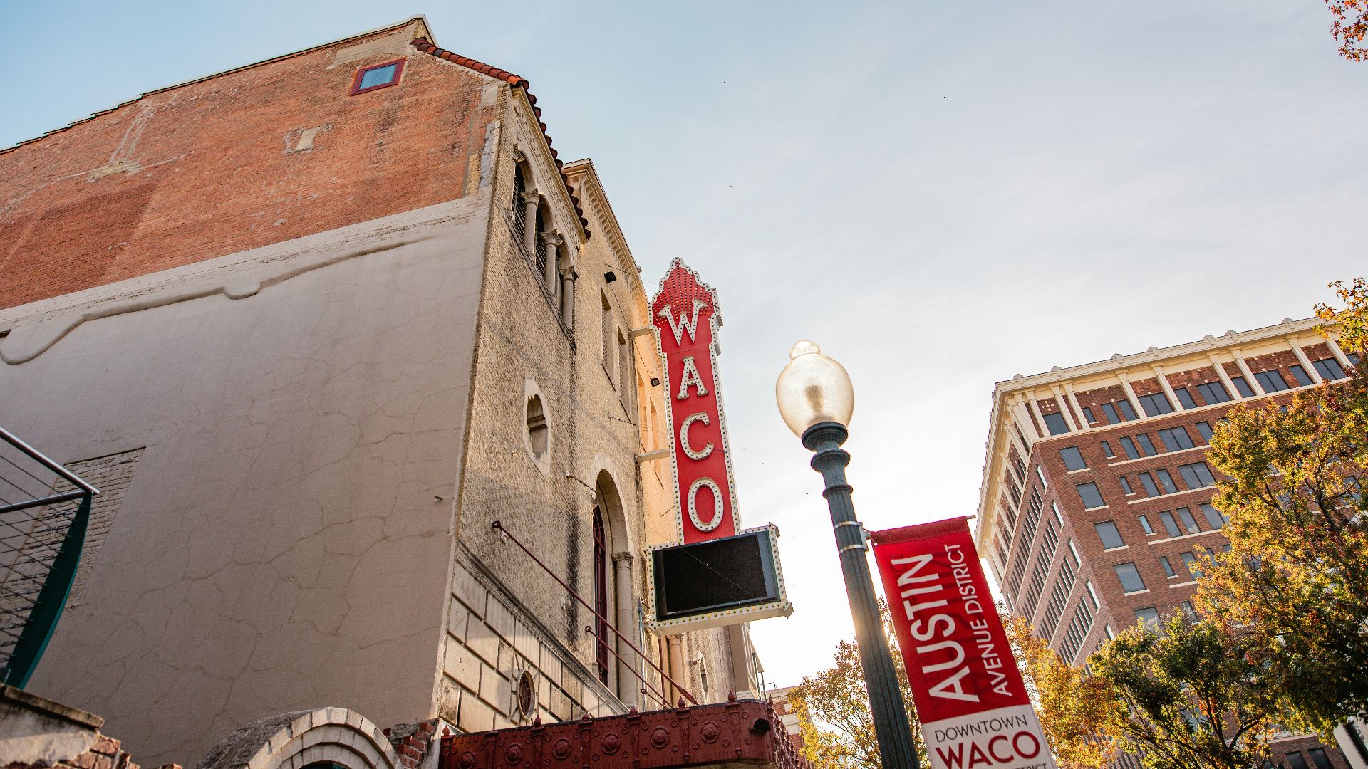 a tall building with a red sign on the side of it
