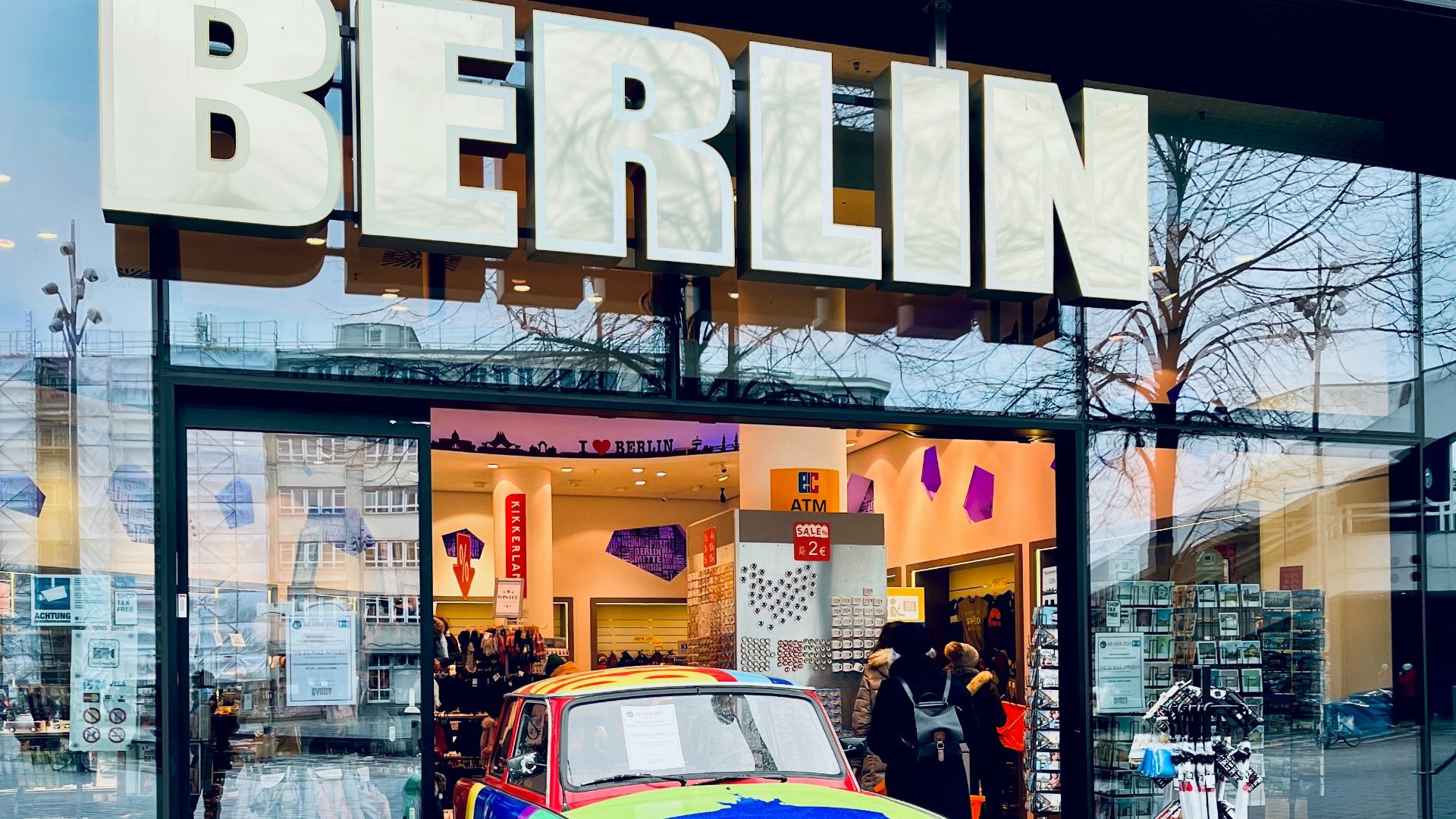 a colorful car is parked in front of a store