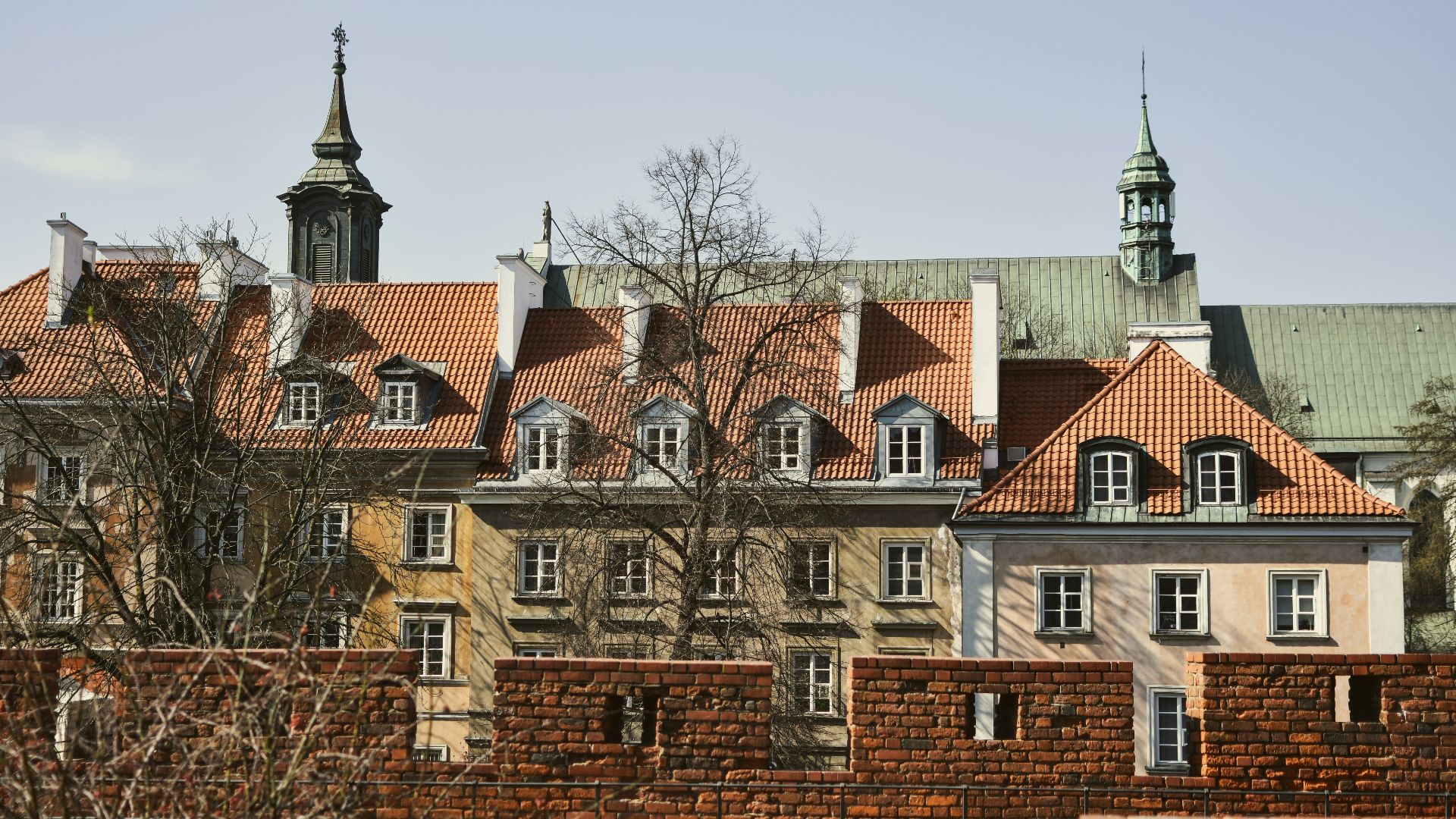 Buildings with red roofs are seen on a sunny day.