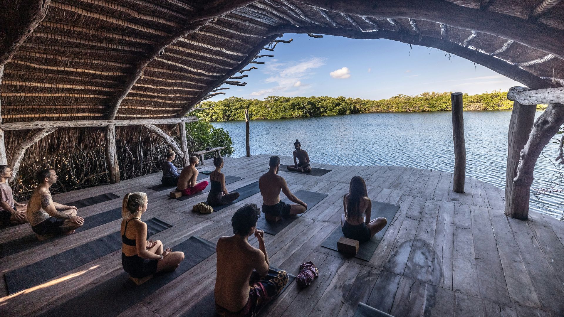 a group of people sitting on top of a wooden floor