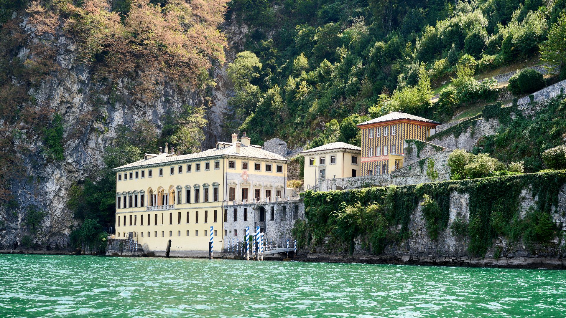a building on a cliff by the water
