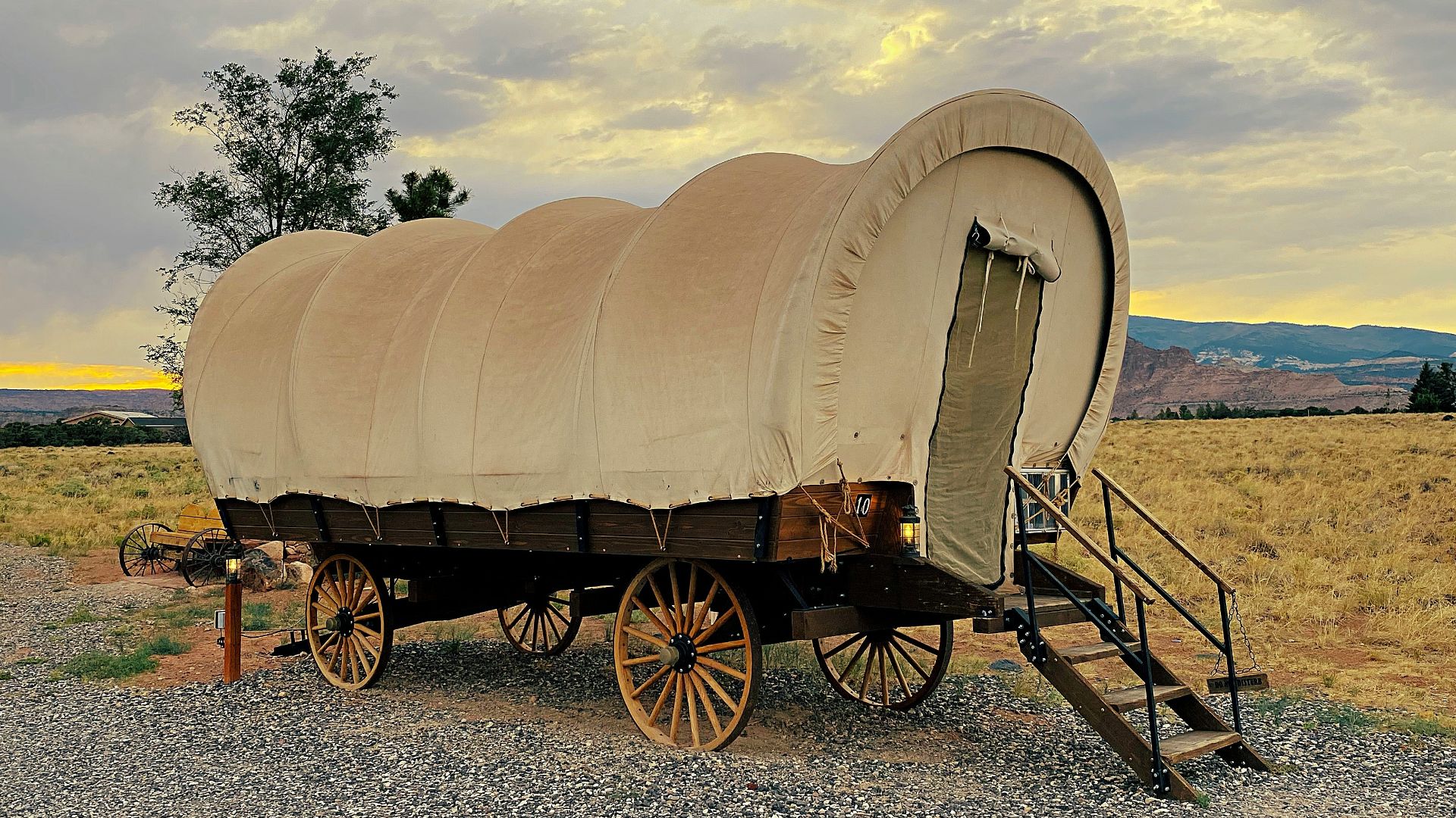 brown wooden carriage on gray sand during daytime
