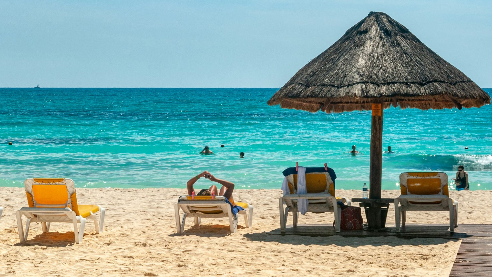 brown beach umbrellas on beach during daytime