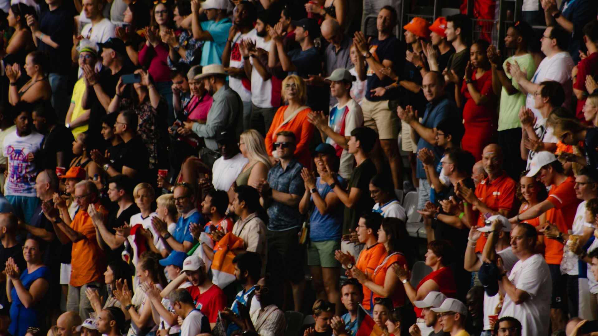 A crowd of people watching a tennis match