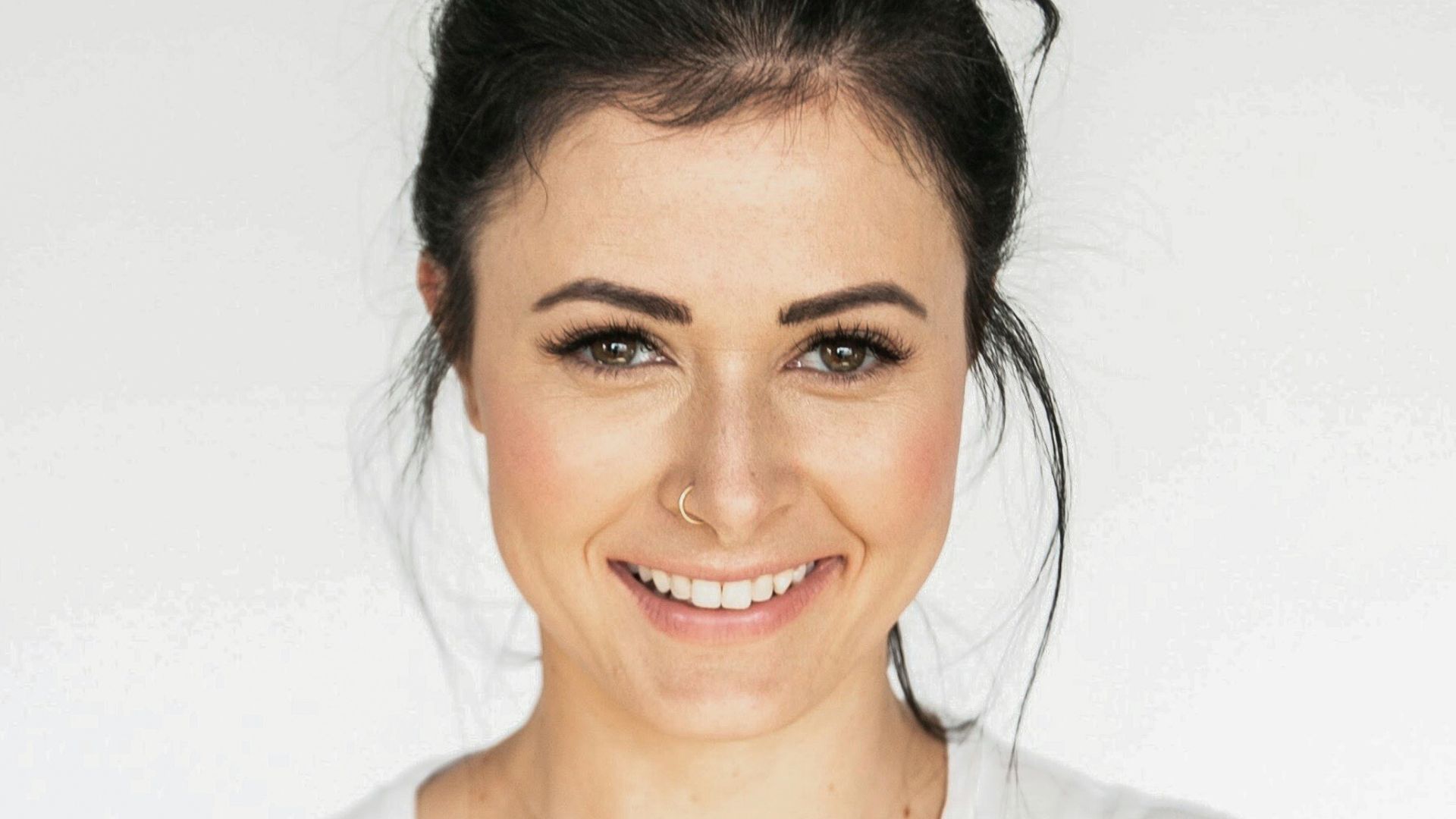 woman in white crew neck shirt smiling