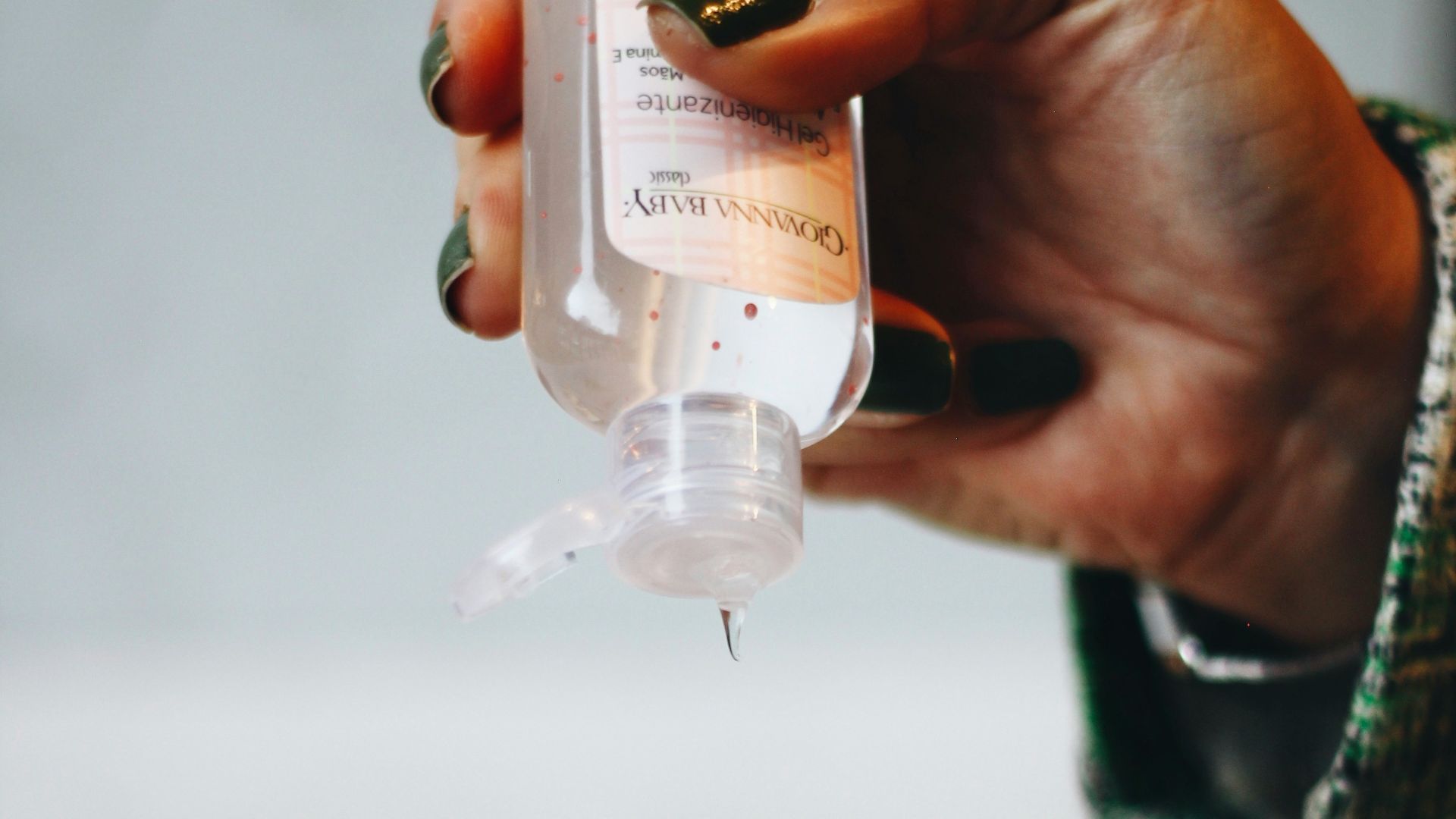 person holding clear plastic bottle