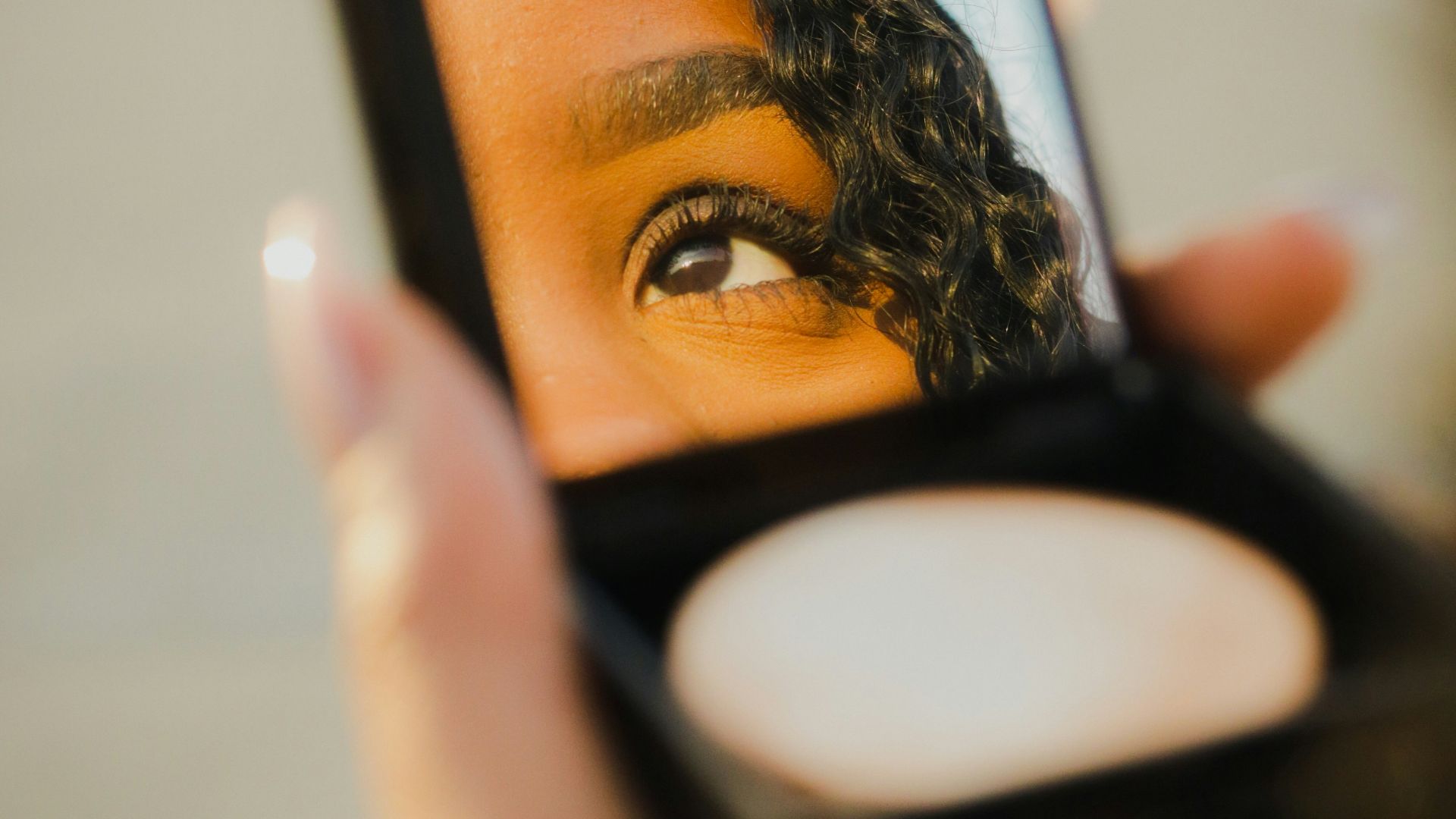 a woman holding a compact compact compact compact compact compact compact compact compact compact compact compact