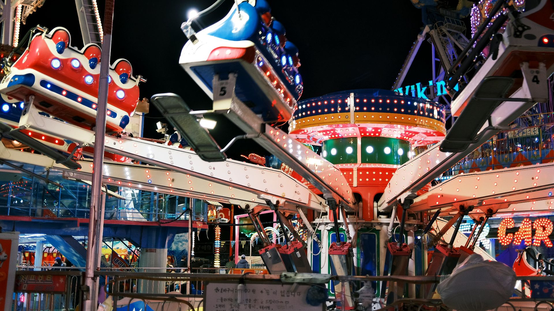 an amusement park at night with rides and rides