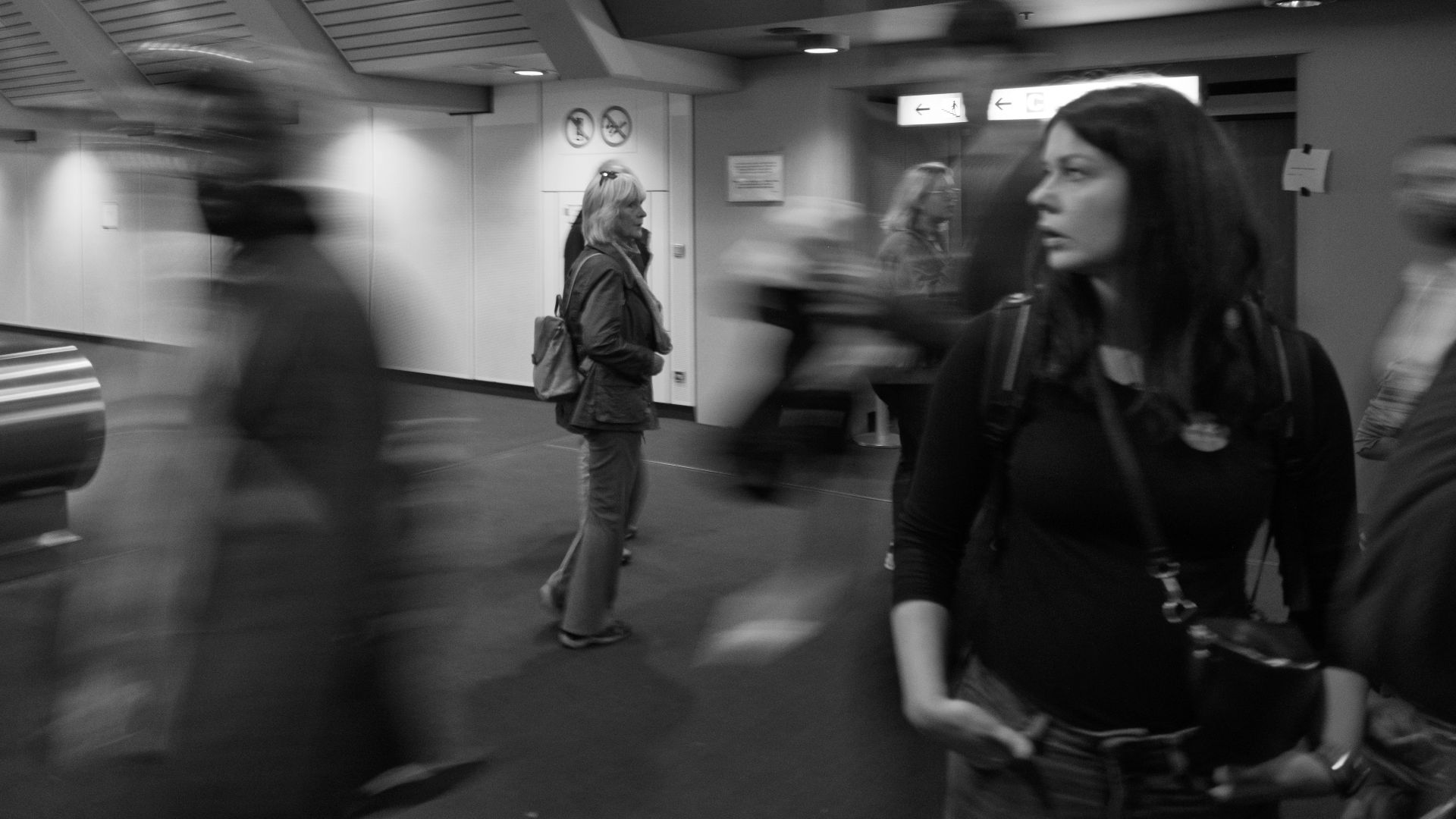 Woman looking away in a busy, blurred station
