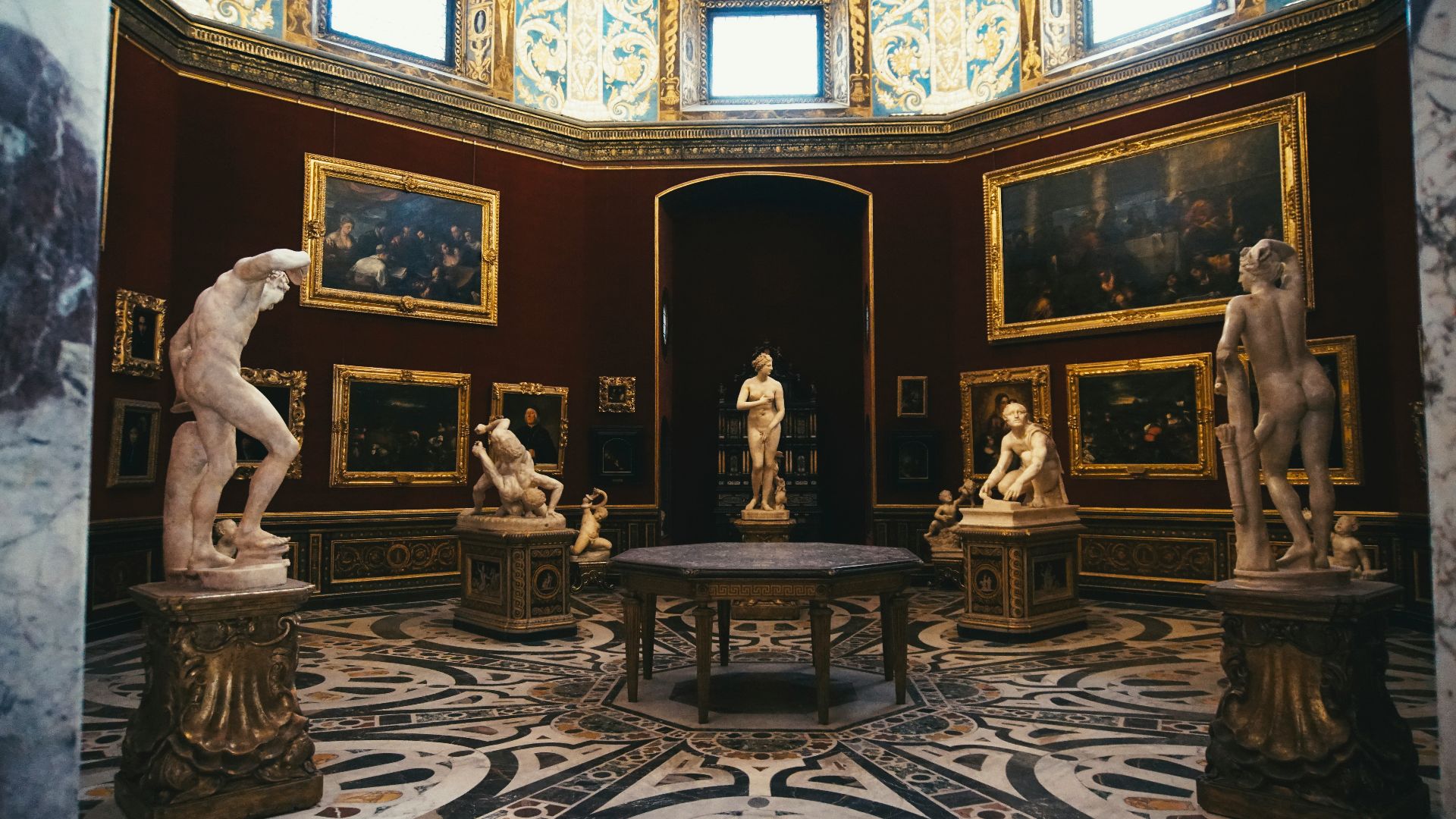 a room filled with statues of men and women