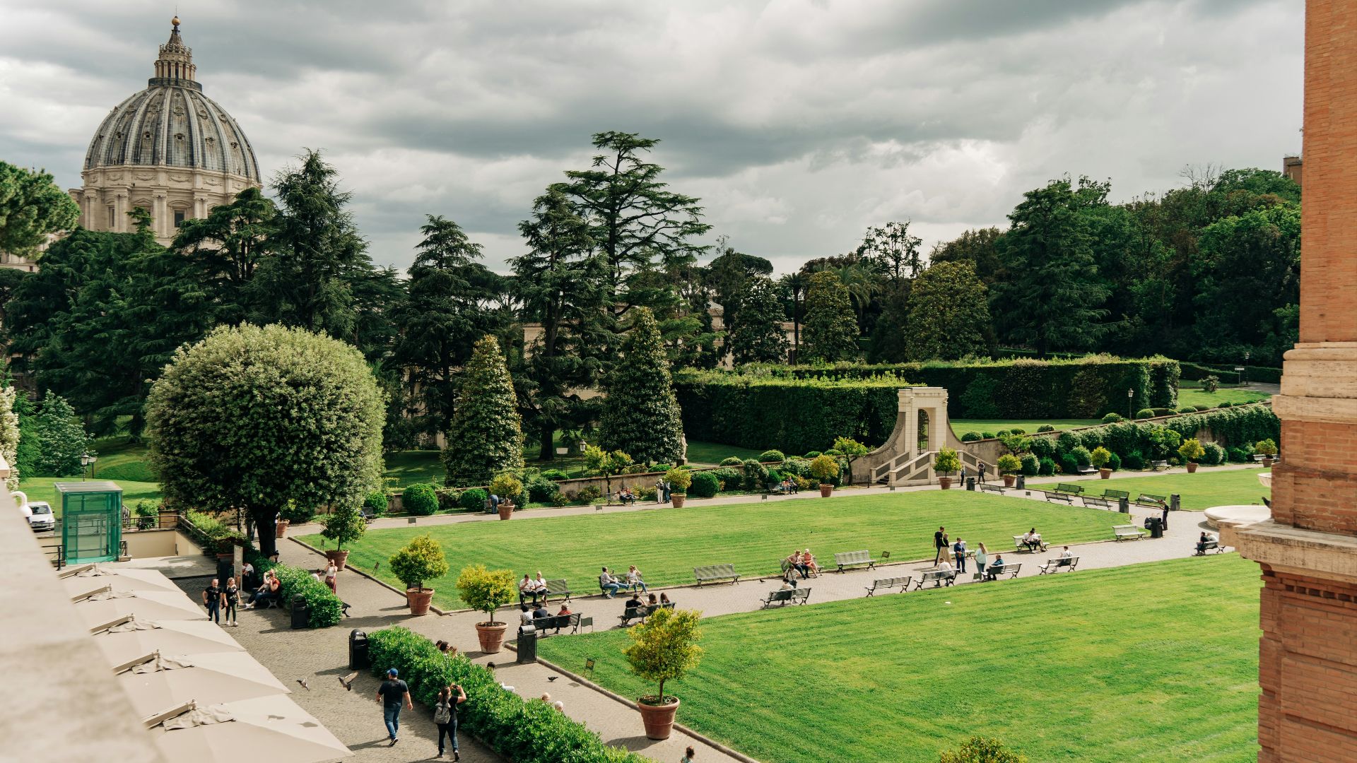 a lush green park with a domed building in the background