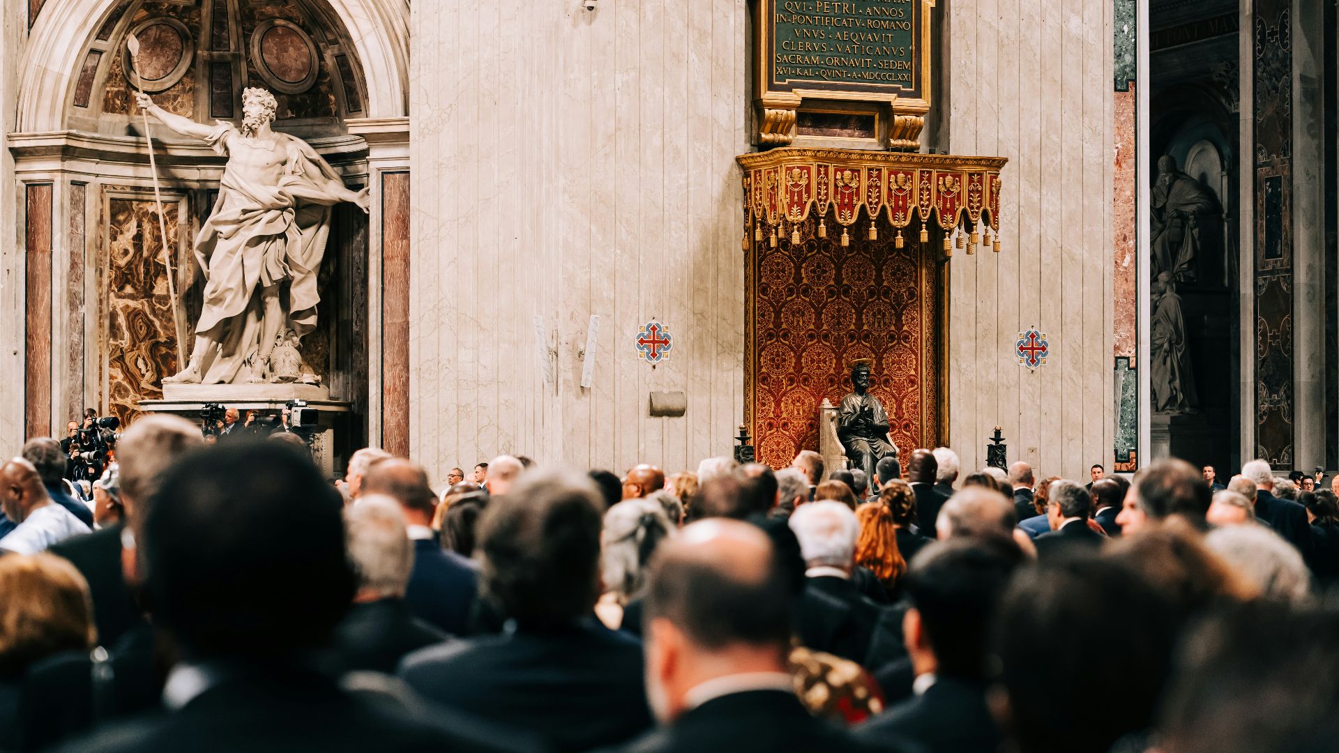 a crowd of people standing around a statue