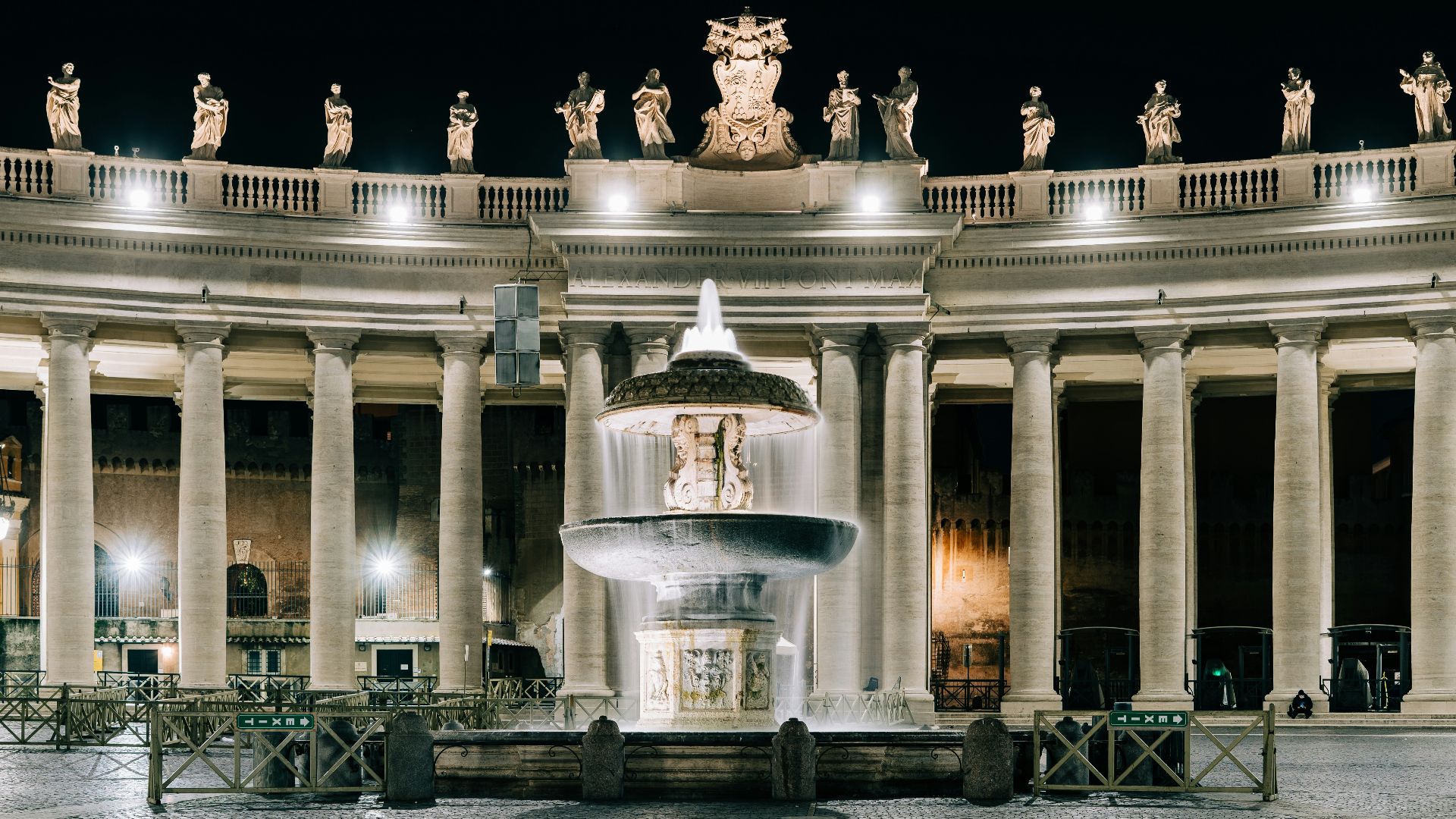 water fountain in front of building during night time