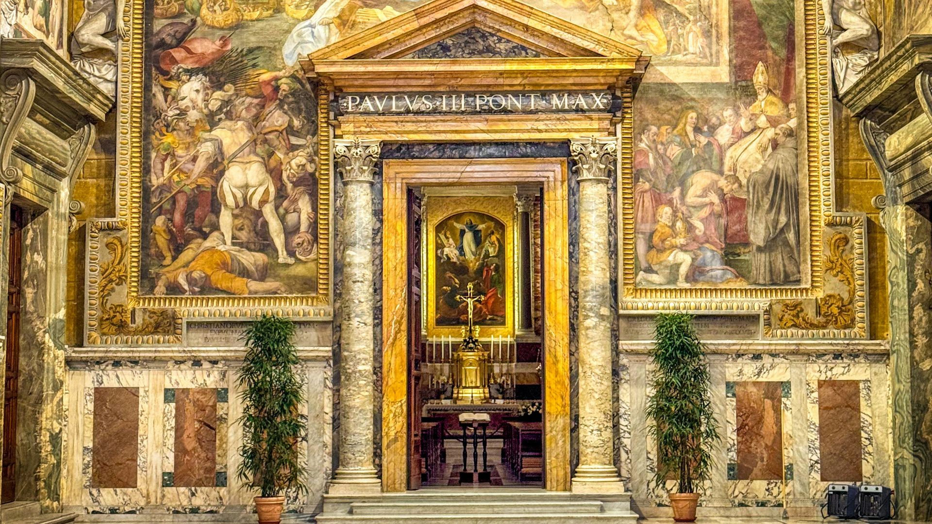 Ornate room with detailed paintings and marble flooring.